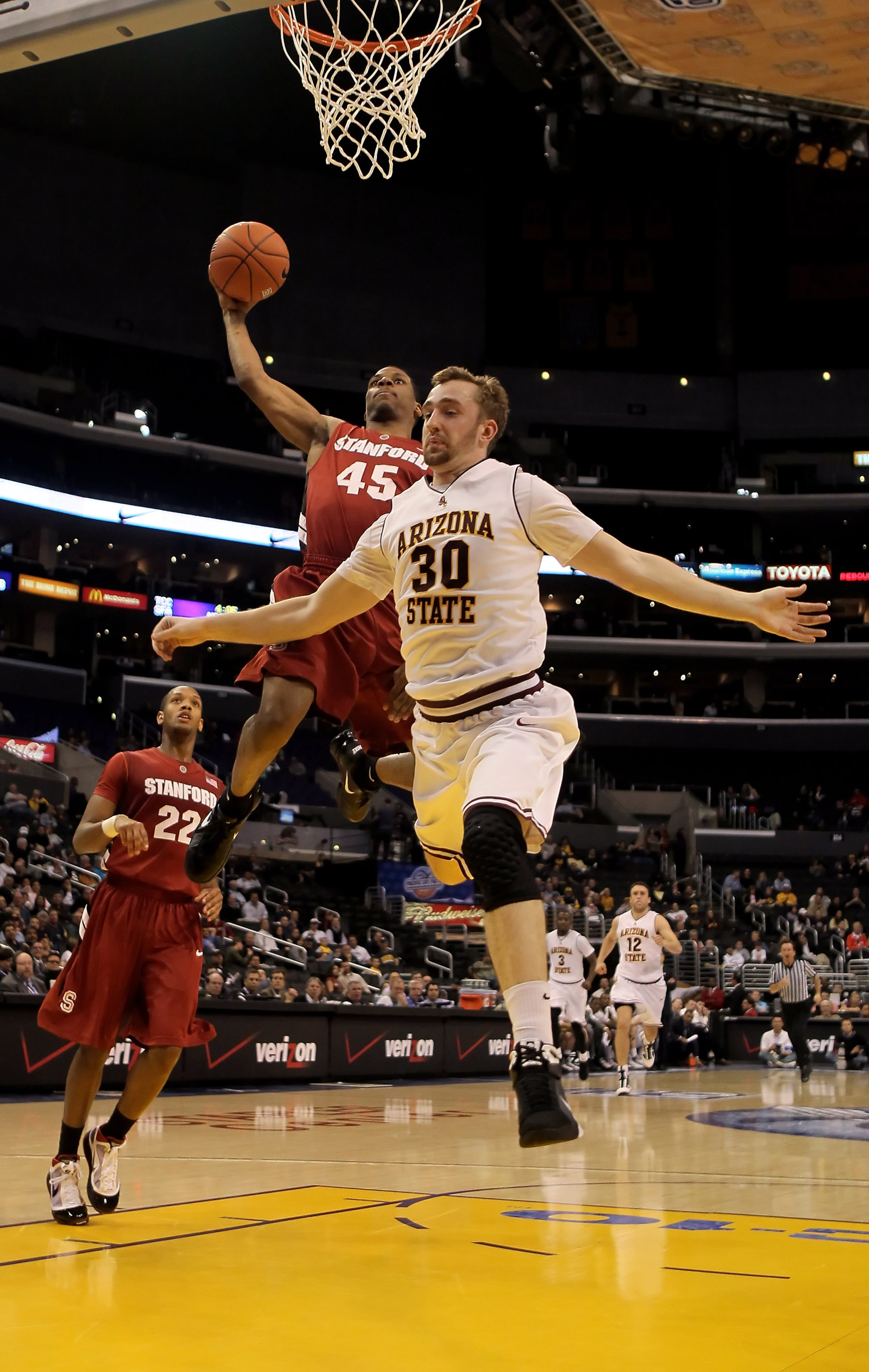 LOS ANGELES, CA - MARCH 11:  Jeremy Green #45 of the Stanford Cardinal drives to the basket past Rihards Kuksiks #30 of the Arizona State Sun Devils in the second half during the Quarterfinals of the Pac-10 Basketball Tournament at Staples Center on March