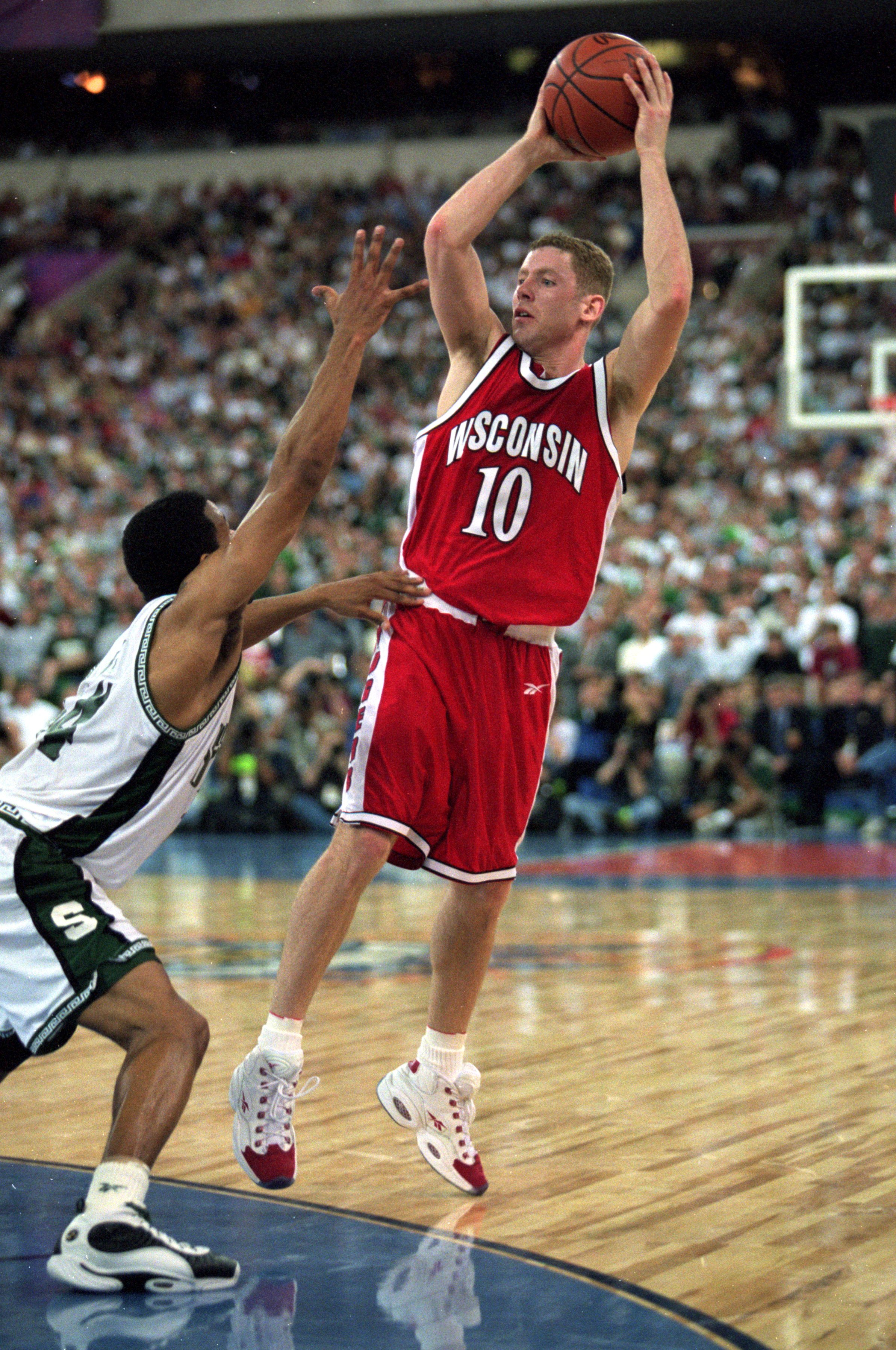 Jon Bryant #10 of the Wisconsin Badgers leaps to catch the ball during the NCAA Men''s Finals Four Game against the Michigan State Spartans at the RCA Dome in Indianapolis, Indiana. The Spartans defeated the Badgers 53-41.
