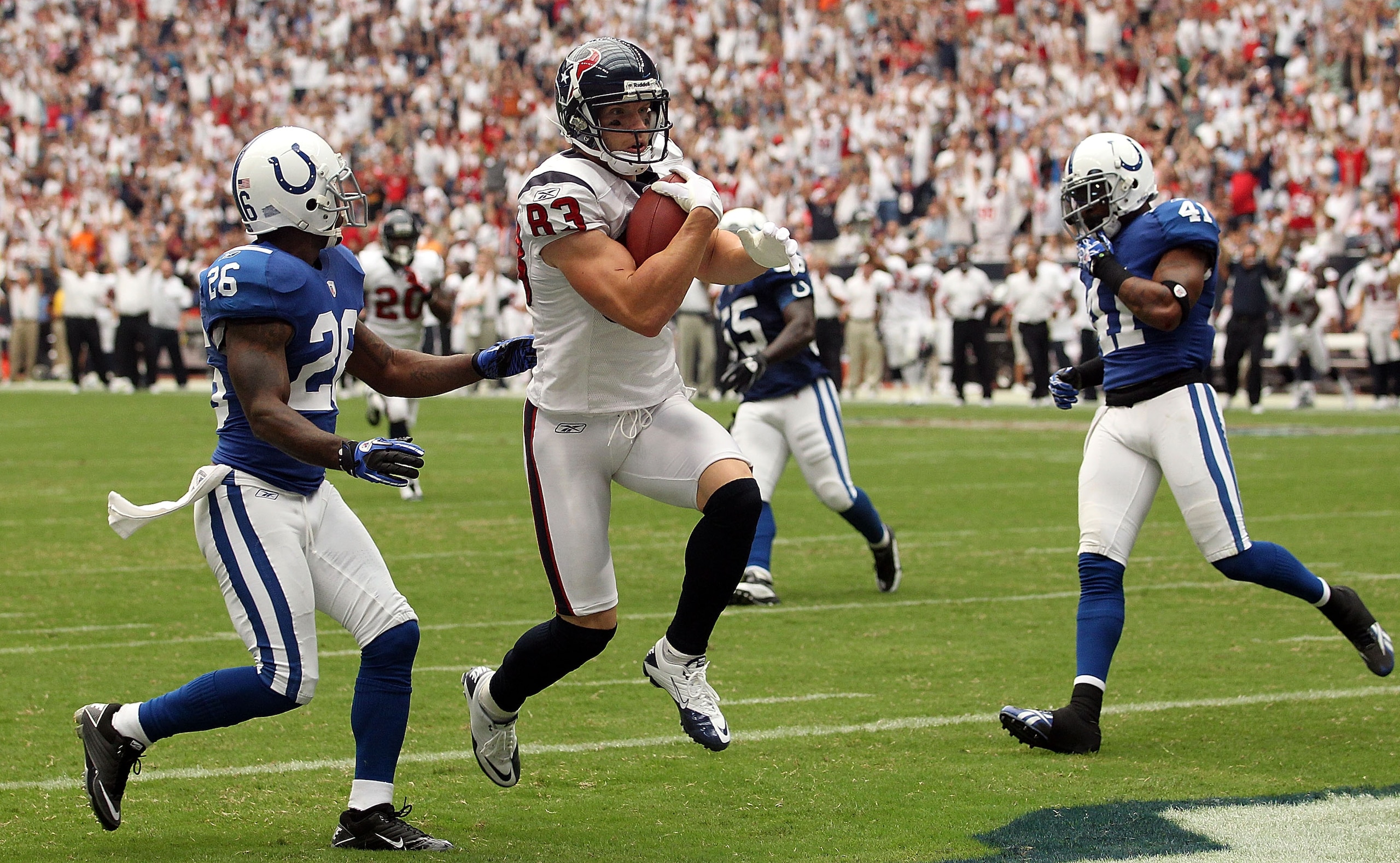 HOUSTON - SEPTEMBER 12:  Wide receiver Kevin Walter #83 of the Houston Texans runs for a touchdown past Kelvin Hayden #26 of the Indianapolis Colts during the NFL season opener at Reliant Stadium on September 12, 2010 in Houston, Texas.  (Photo by Ronald