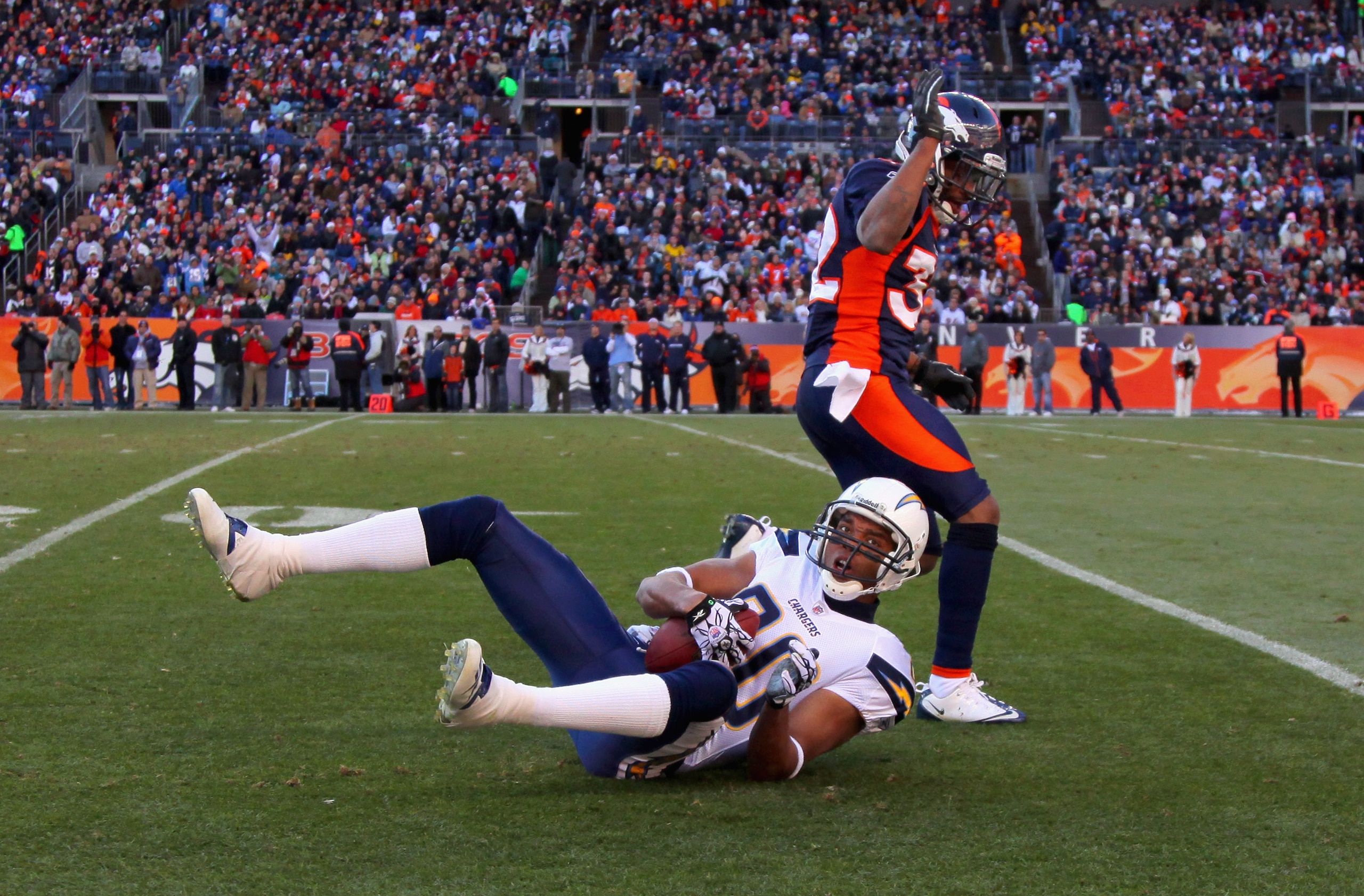 DENVER - JANUARY 02:  Wide receiver Malcom Floyd #80 of the San Diego Chargers hangs on to the ball for a first down reception after Perrish Cox #32 of the Denver Broncos was called for pass interference at INVESCO Field at Mile High on January 2, 2011 in