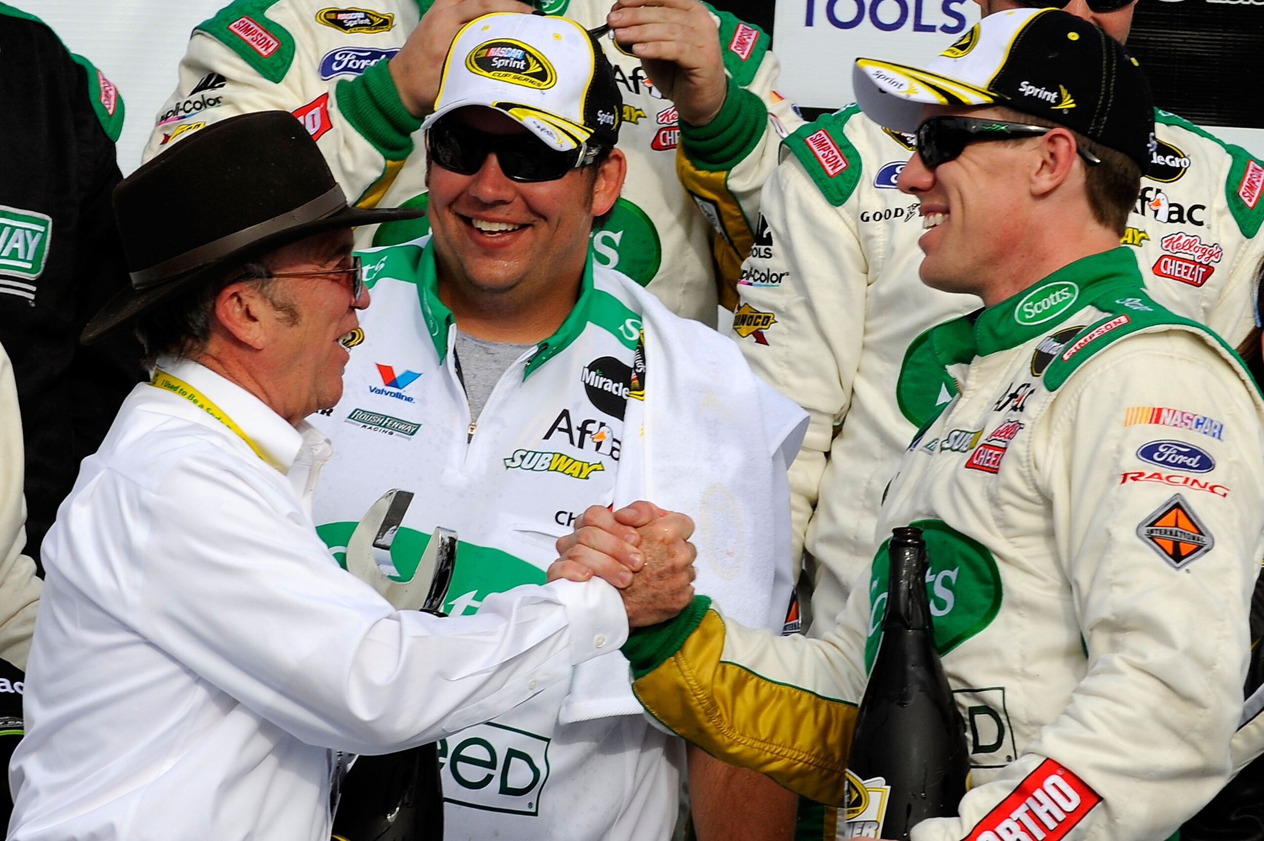 LAS VEGAS, NV - MARCH 06:  Team owner Jack Roush (L) shakes hands with Carl Edwards, driver of the #99 Scotts/Kellogg's Ford, in Victory Lane after winning the NASCAR Sprint Cup Series Kobalt Tools 400 at Las Vegas Motor Speedway on March 6, 2011 in Las V