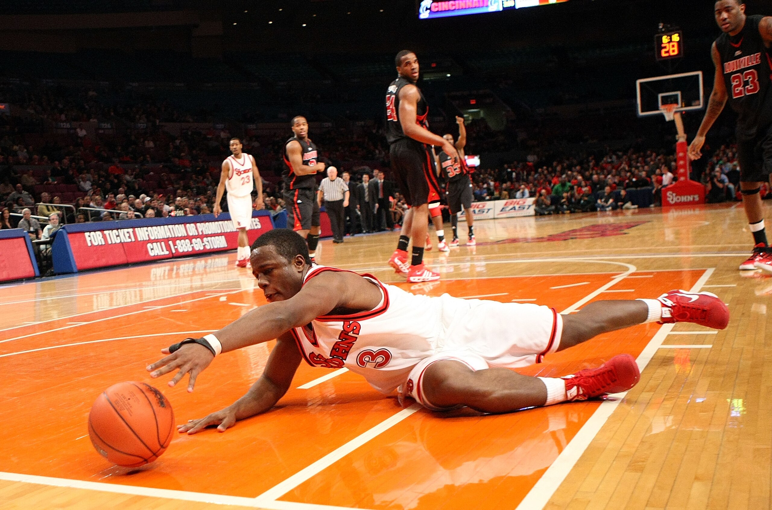 NEW YORK - FEBRUARY 08:  Malik Boothe #3 of St John's Red Storm dives to keep the ball in bounds against the Louisville Cardinals  on February 8, 2009 at Madison Square Garden in New York City, New York.  (Photo by Nick Laham/Getty Images)