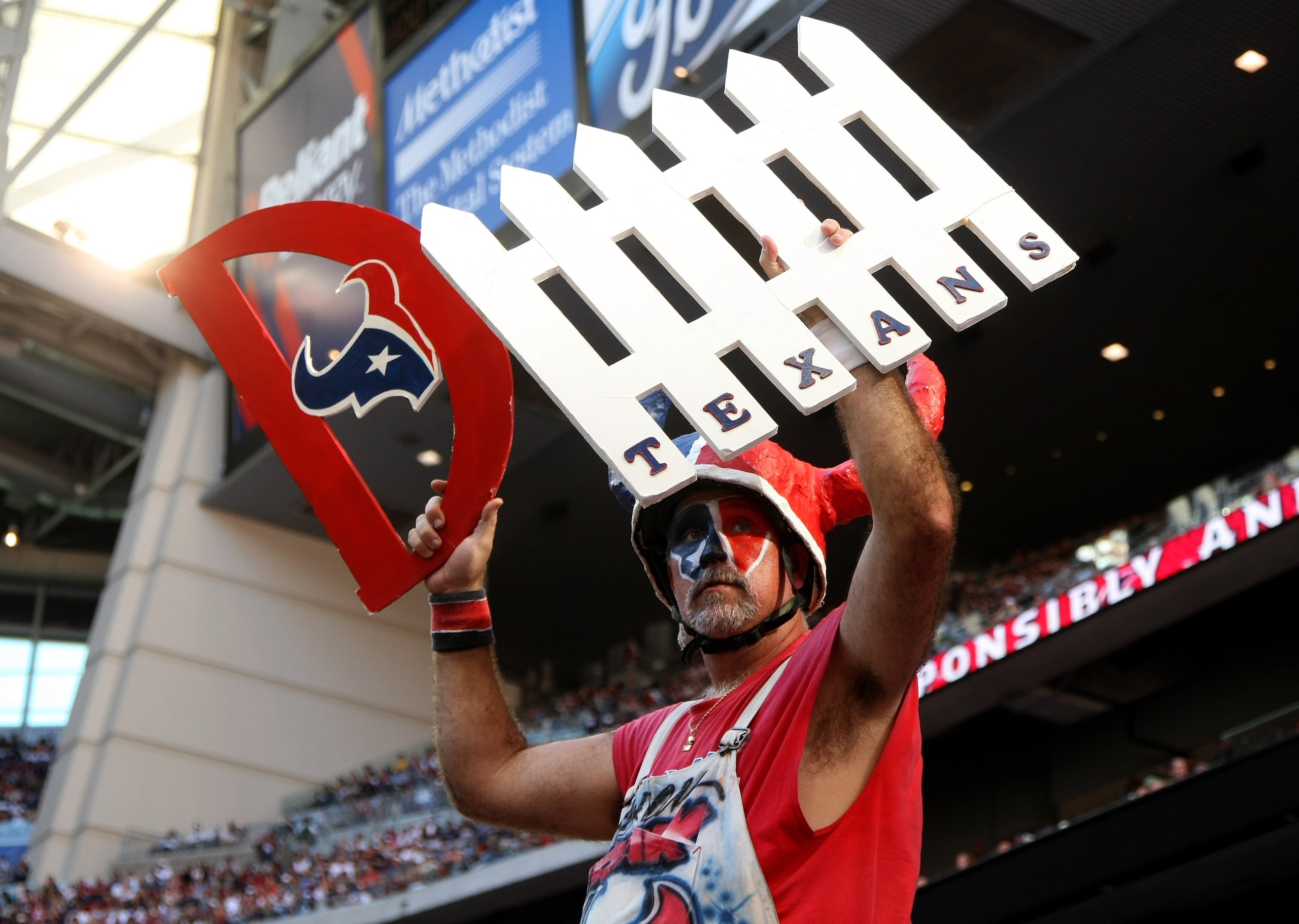 HOUSTON - OCTOBER 26:  A Texans fan holds up his signs during the game between the Cincinnati Bengals and the Houston Texans on October 26, 2008 at Reliant Stadium in Houston, Texas.  (Photo by Stephen Dunn/Getty Images)