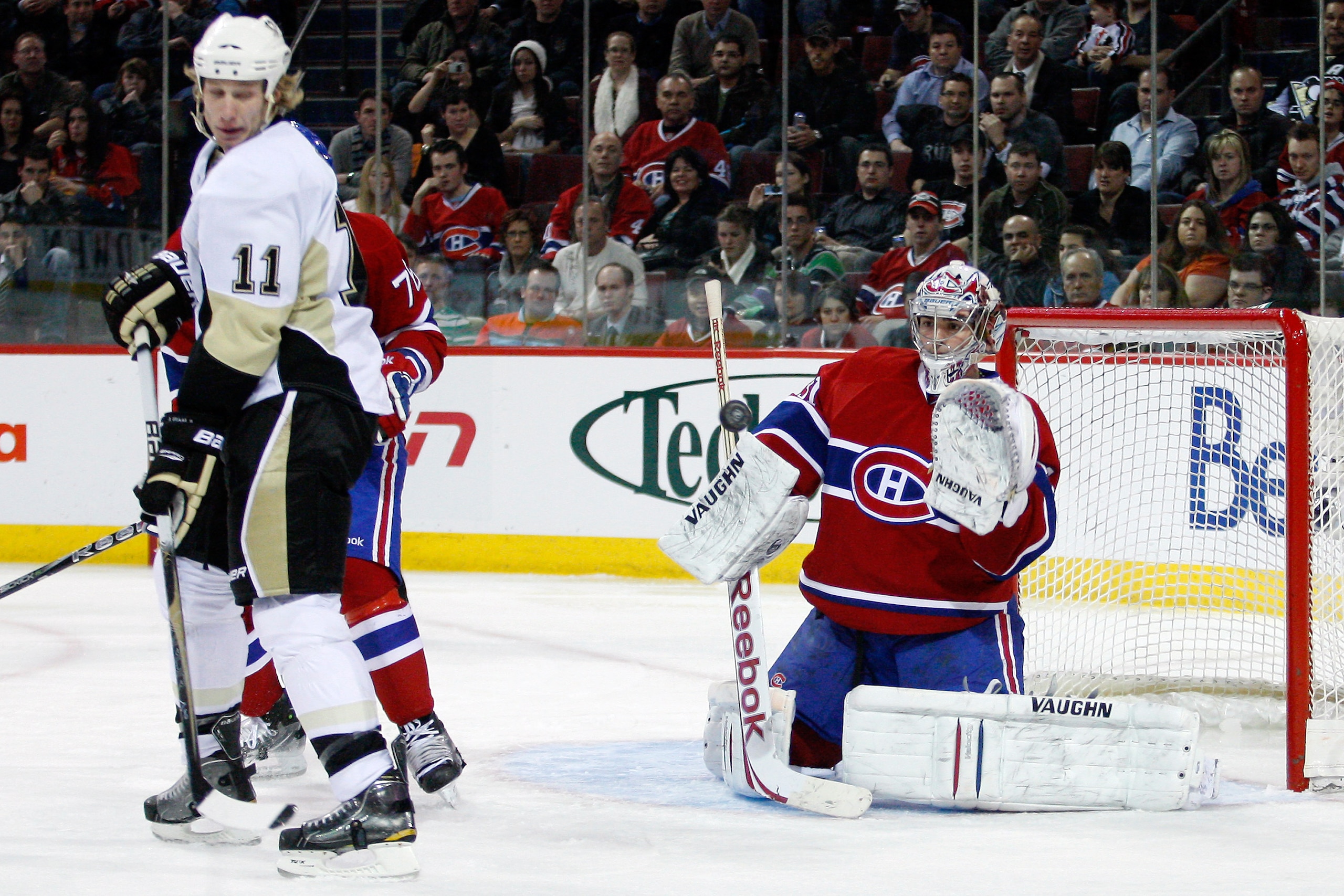 MONTREAL, CANADA - JANUARY 12: Carey Price #31 of the Montreal Canadiens makes a glove save on the deflected puck by Jordan Staal #11 of the Pittsburgh Penguins during the NHL game at the Bell Centre on January 12, 2011 in Montreal, Quebec, Canada. The MONTREAL, CANADA - JANUARY 12: Carey Price #31 of the Montreal Canadiens makes a glove save on the deflected puck by Jordan Staal #11 of the Pittsburgh Penguins during the NHL game at the Bell Centre on January 12, 2011 in Montreal, Quebec, Canada. The