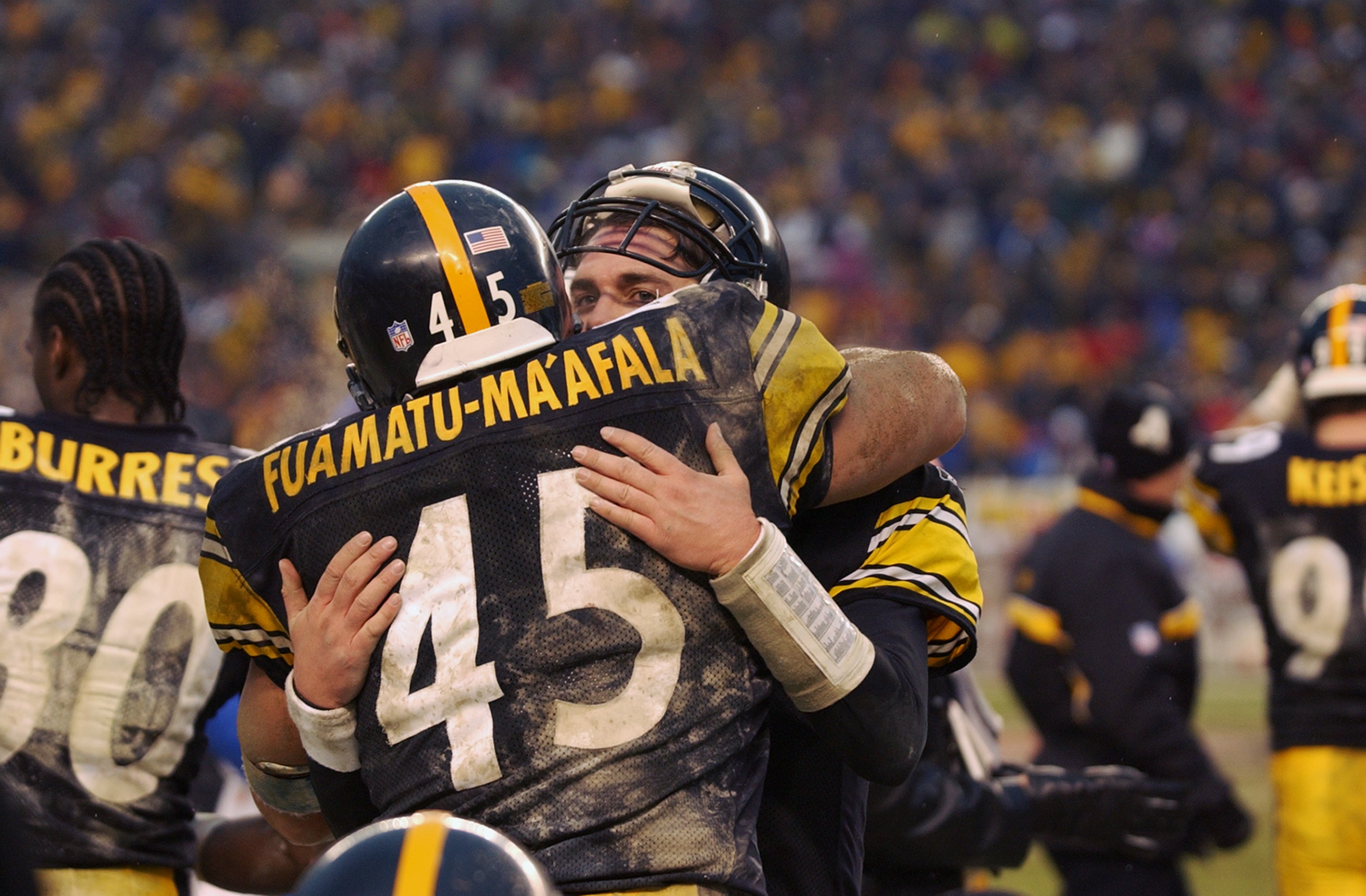 PITTSBURGH, PA - JANUARY 5:  Tommy Maddox #8 of the Pittsburgh Steelers hugs teammate Chris Fuamatu-Ma atala #45  after the AFC Wild Card game against the Cleveland Browns at Heinz Field on January 5, 2003 in Pittsburgh, Pennsylvania. The Steelers won 36-