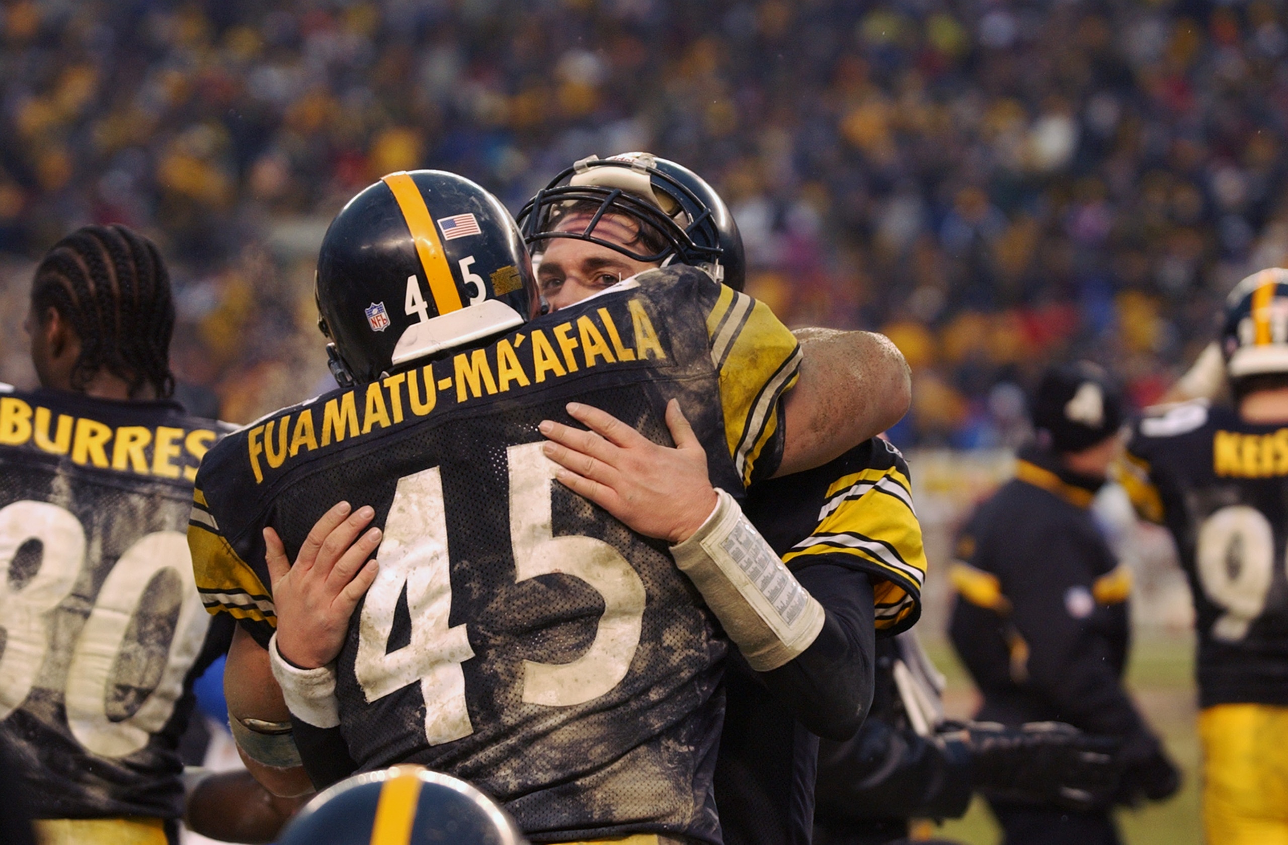 PITTSBURGH, PA - JANUARY 5:  Tommy Maddox #8 of the Pittsburgh Steelers hugs teammate Chris Fuamatu-Ma atala #45  after the AFC Wild Card game against the Cleveland Browns at Heinz Field on January 5, 2003 in Pittsburgh, Pennsylvania. The Steelers won 36-
