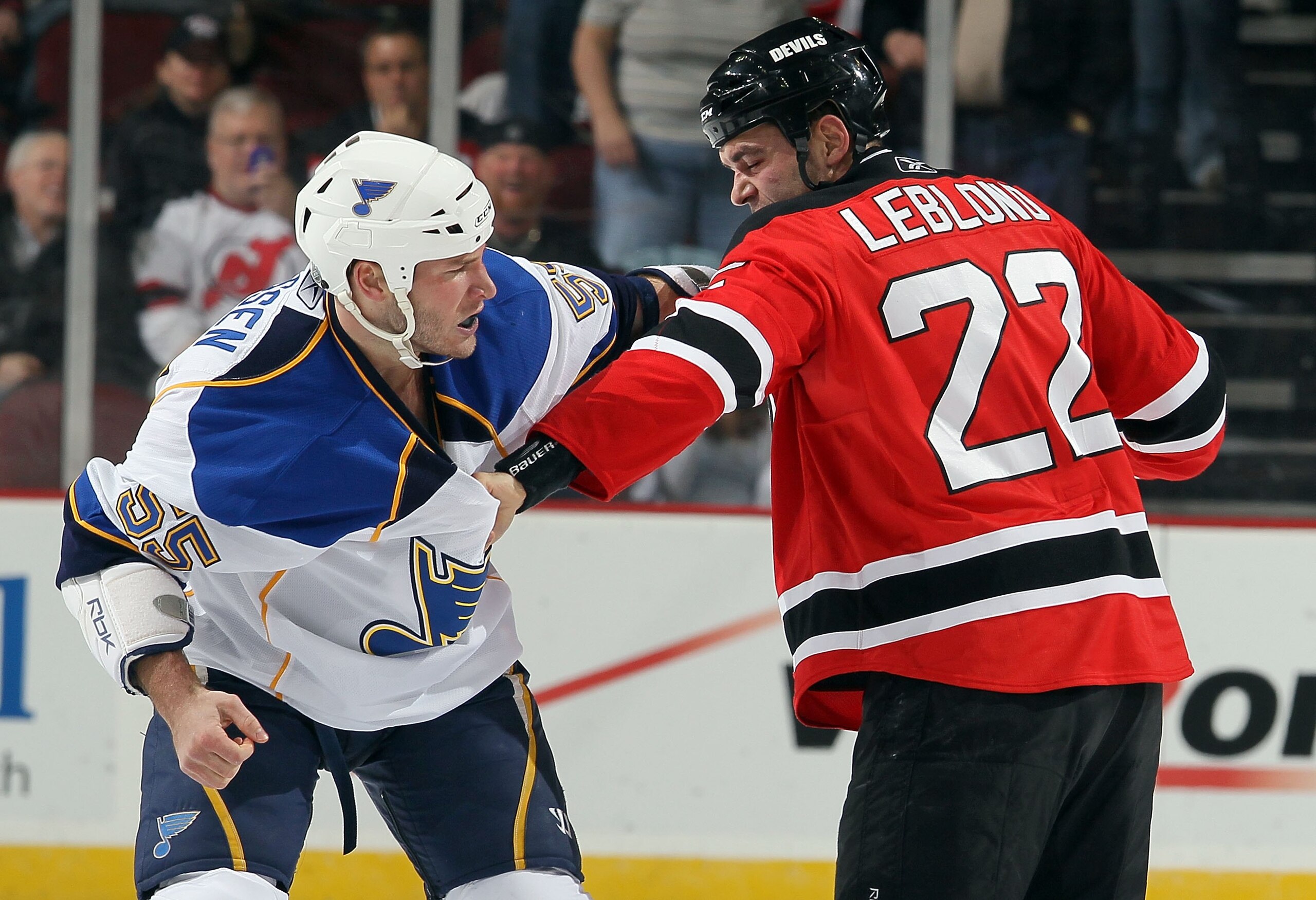 NEWARK, NJ - MARCH 20:  Cam Janssen #55 of the St. Louis Blues trades punches with Pierre-Luc Letourneau-Leblond #22 of the New Jersey Devils during their first period fight at the Prudential Center on March 20, 2010 in Newark, New Jersey.  (Photo by Jim