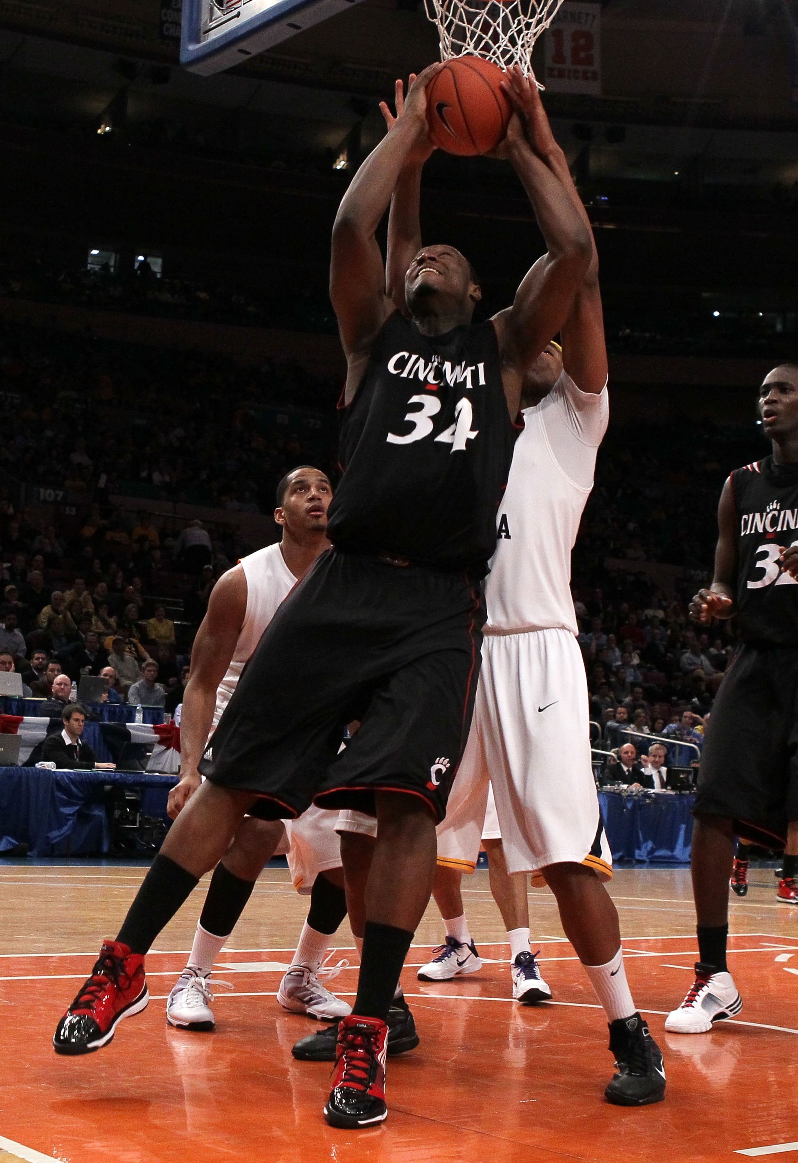 NEW YORK - MARCH 11: Yancy Gates #34 of the Cincinnati Bearcats goes up with the ball against the West Virginia Mountaineers during the quarterfinal of the 2010 NCAA Big East Tournament at Madison Square Garden on March 11, 2010 in New York City.  (Photo