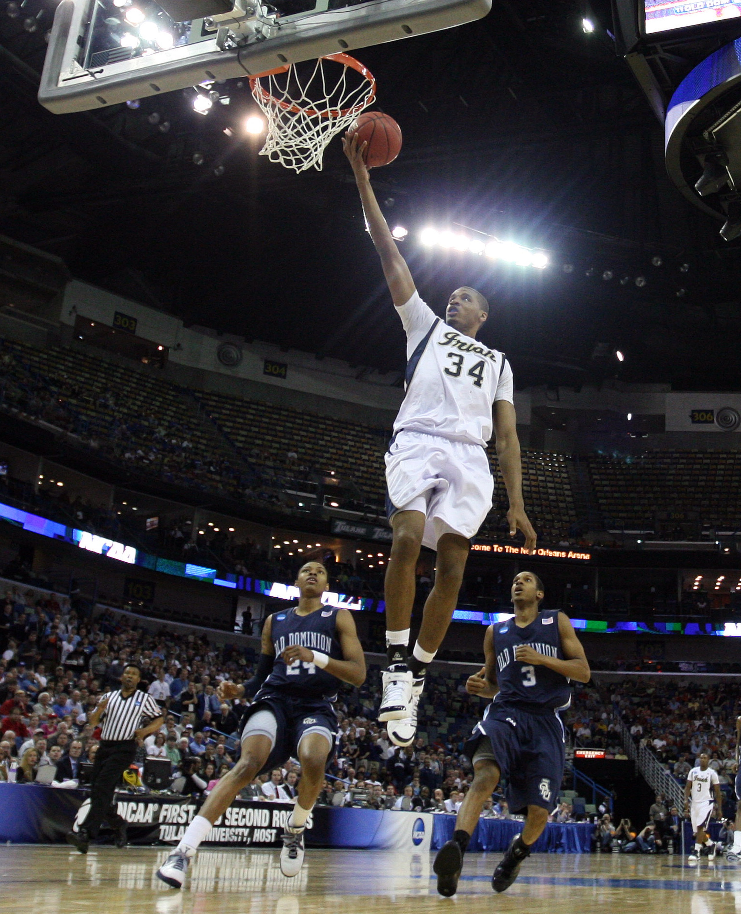 NEW ORLEANS - MARCH 18:  Carleton Scott #34 of the Notre Dame Fighting Irish scores despite the defense of the Old Dominion Monarchs Darius James (3) and Kent Bazemore (24) during the first round of the 2010 NCAA mens basketball tournament at the New Orle