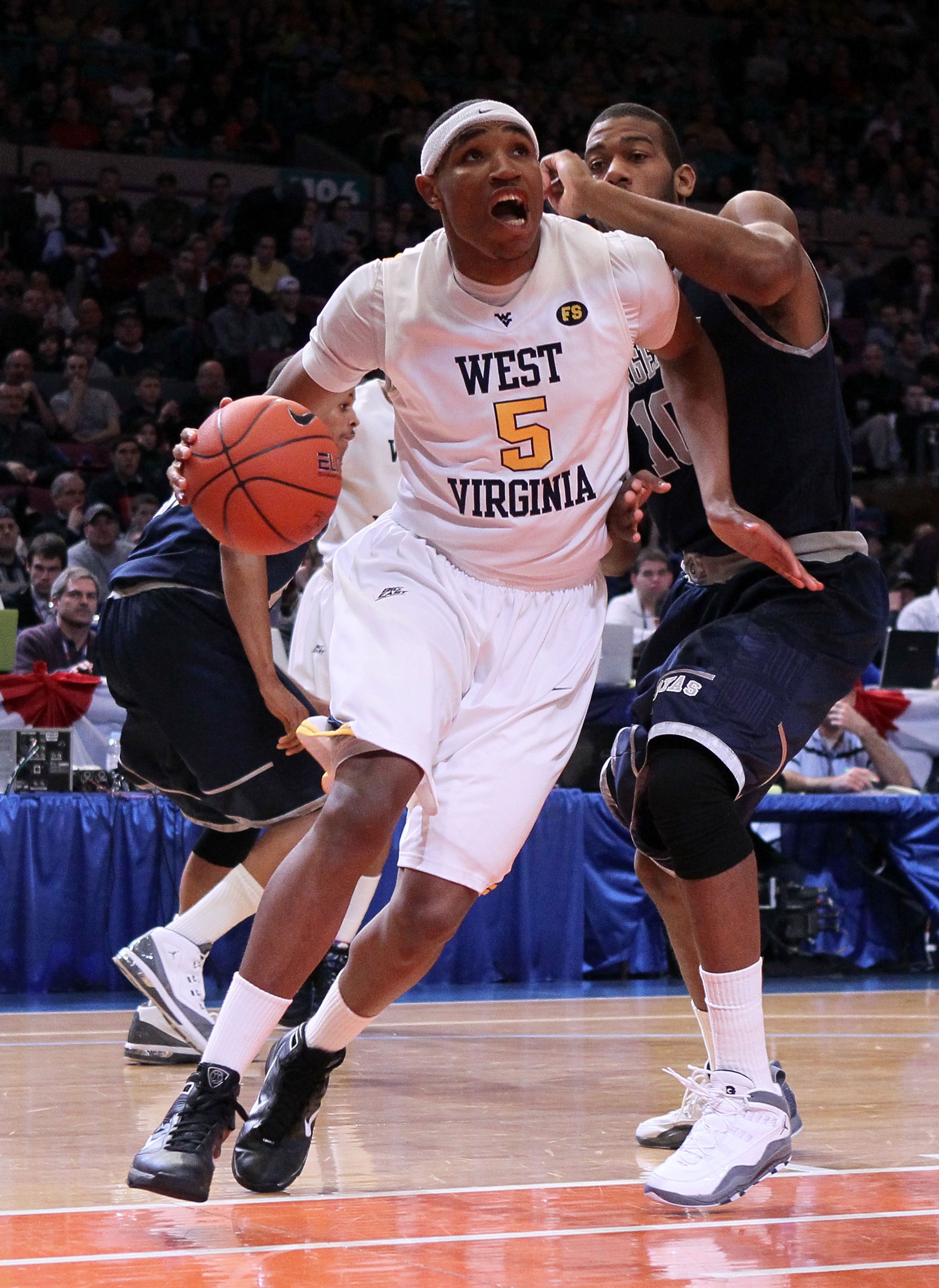 NEW YORK - MARCH 13:  Kevin Jones #5 of the West Virginia Mountaineers drives with the ball against Greg Monroe #10 of the Georgetown Hoyas during the championship of the 2010 NCAA Big East Tournament at Madison Square Garden on March 13, 2010 in New York