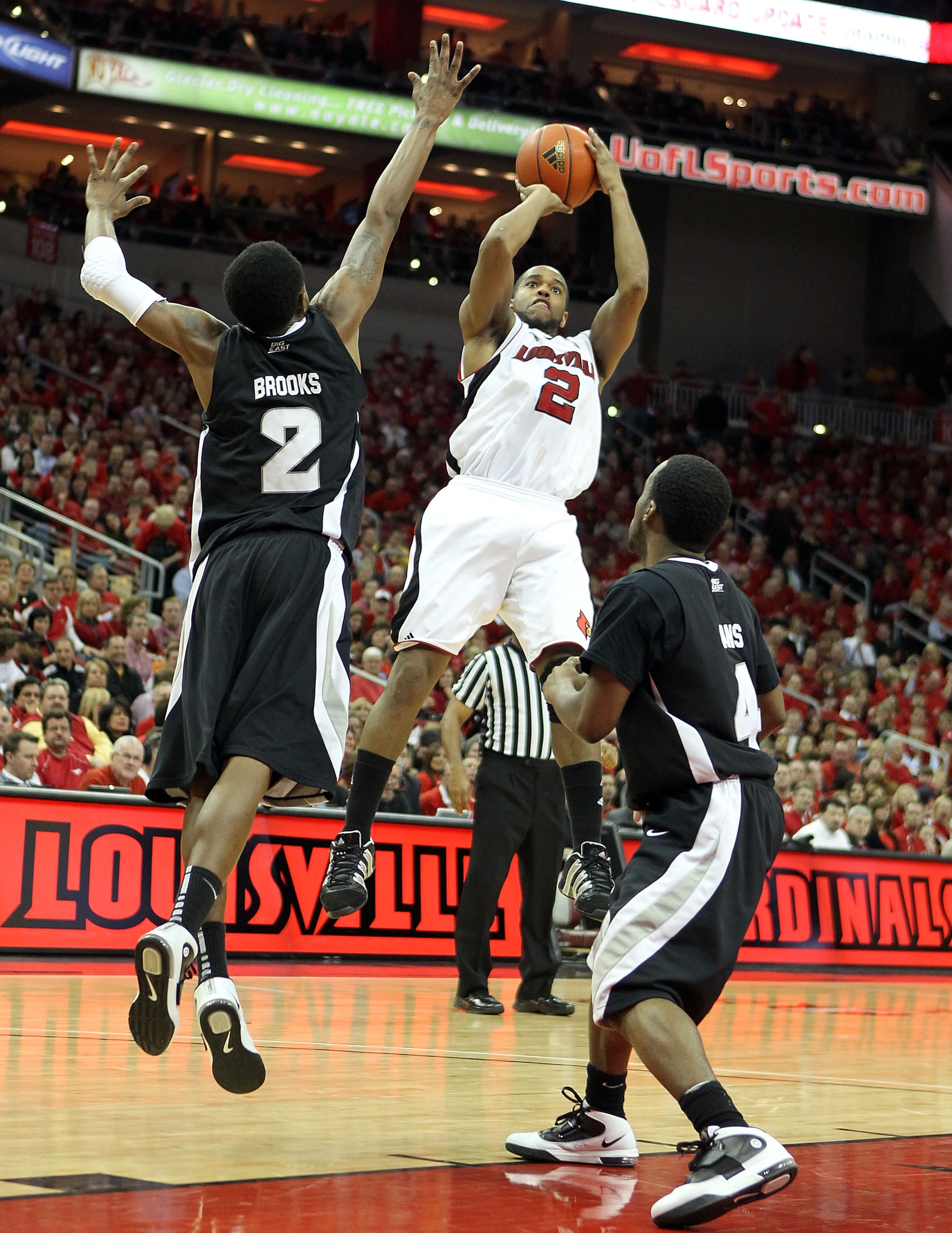 LOUISVILLE, KY - MARCH 02:  Preston Knowles #2 of the Louisville Cardinals shoots the ball while defended by Marshon Brooks #2 and Dre Evans #4  of the Providence Friars during the Big East Conference game at the KFC Yum! Center on March 2, 2011 in Louisv
