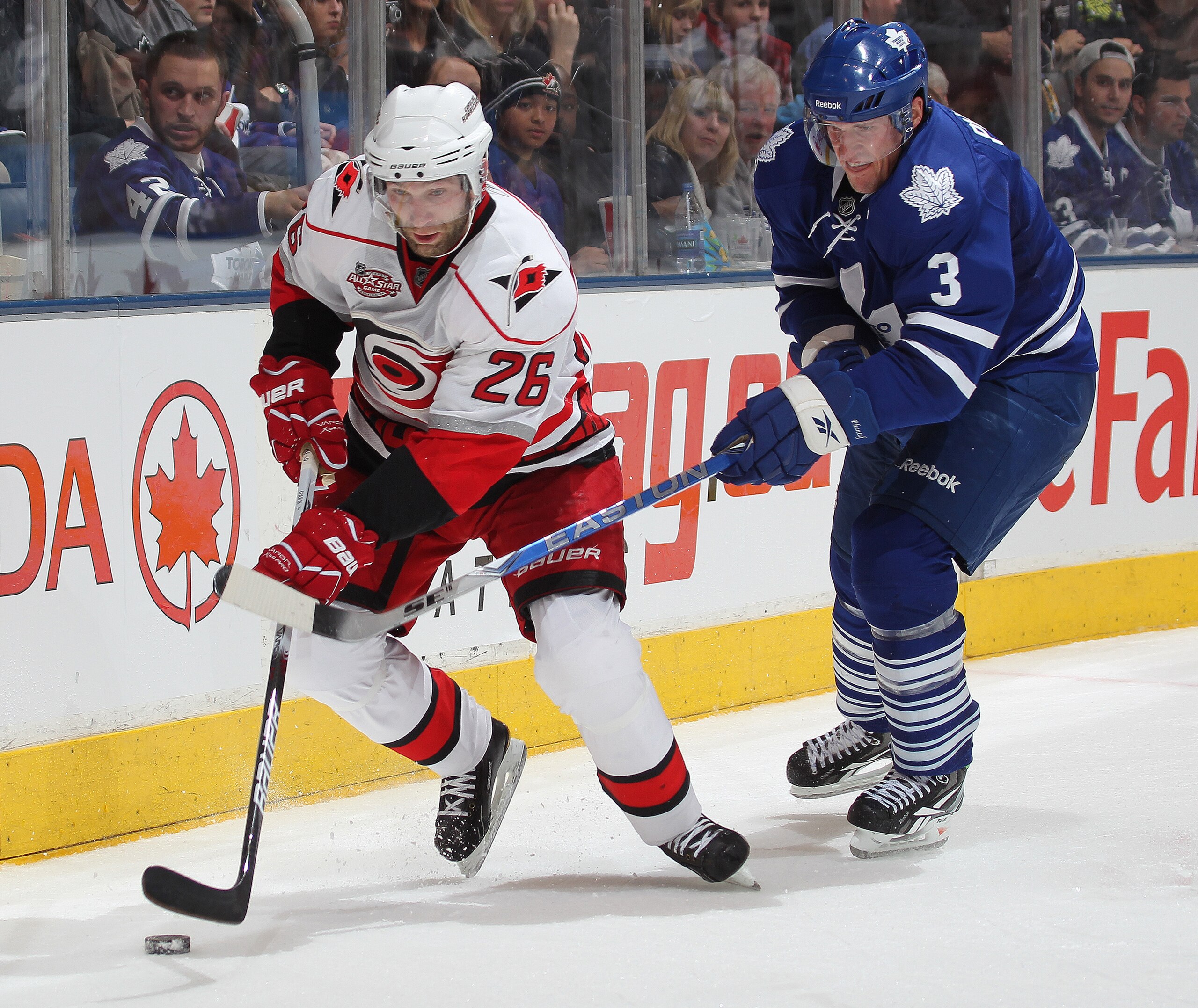 TORONTO, ON - DECEMBER 28: Erik Cole #26 of the Carolina Hurricanes skates away from the check of Dion Phaneuf #3 of the Toronto Maple Leafs in a game on December 28, 2010 at the Air Canada Centre in Toronto,Ontario. The Hurricanes defeated the Leafs 4-3 TORONTO, ON - DECEMBER 28: Erik Cole #26 of the Carolina Hurricanes skates away from the check of Dion Phaneuf #3 of the Toronto Maple Leafs in a game on December 28, 2010 at the Air Canada Centre in Toronto,Ontario. The Hurricanes defeated the Leafs 4-3