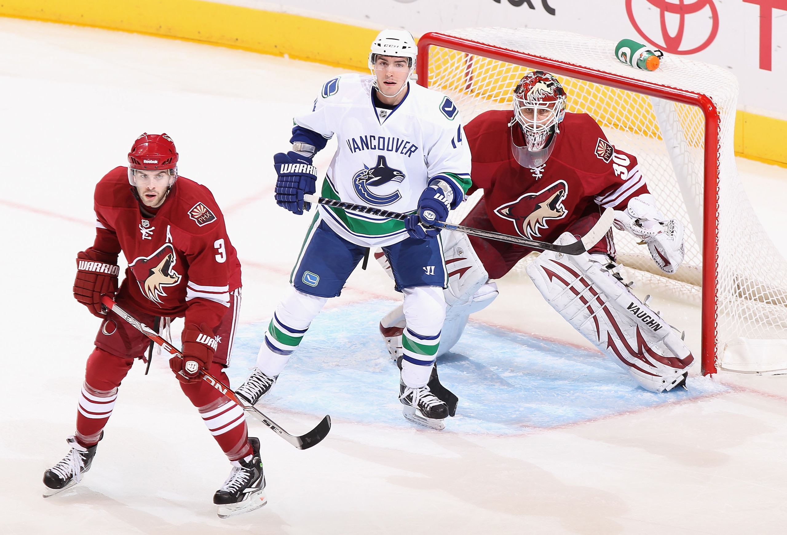 GLENDALE, AZ - FEBRUARY 02: Alex Burrows #14 of the Vancouver Canucks attempts to screen goaltedner Ilya Bryzgalov #30 of the Phoenix Coyotes during the NHL game at Jobing.com Arena on February 2, 2011 in Glendale, Arizona. The Canucks defeated the Coyo GLENDALE, AZ - FEBRUARY 02: Alex Burrows #14 of the Vancouver Canucks attempts to screen goaltedner Ilya Bryzgalov #30 of the Phoenix Coyotes during the NHL game at Jobing.com Arena on February 2, 2011 in Glendale, Arizona. The Canucks defeated the Coyo