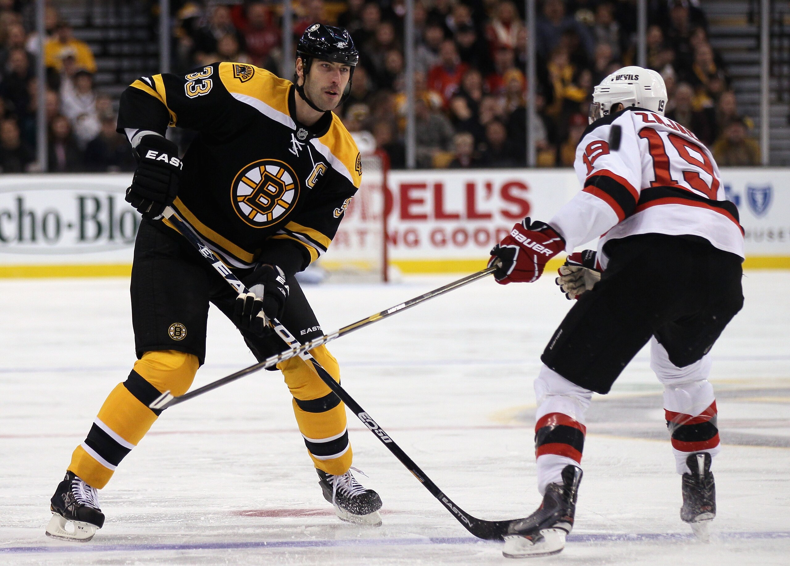 BOSTON - NOVEMBER 15: Zdeno Chara #33 of the Boston Bruins keeps the puck as Travis Zajac #19 of the New Jersey Devils defends on November 15, 2010 at the TD Garden in Boston, Massachusetts. (Photo by Elsa/Getty Images) BOSTON - NOVEMBER 15: Zdeno Chara #33 of the Boston Bruins keeps the puck as Travis Zajac #19 of the New Jersey Devils defends on November 15, 2010 at the TD Garden in Boston, Massachusetts. (Photo by Elsa/Getty Images)