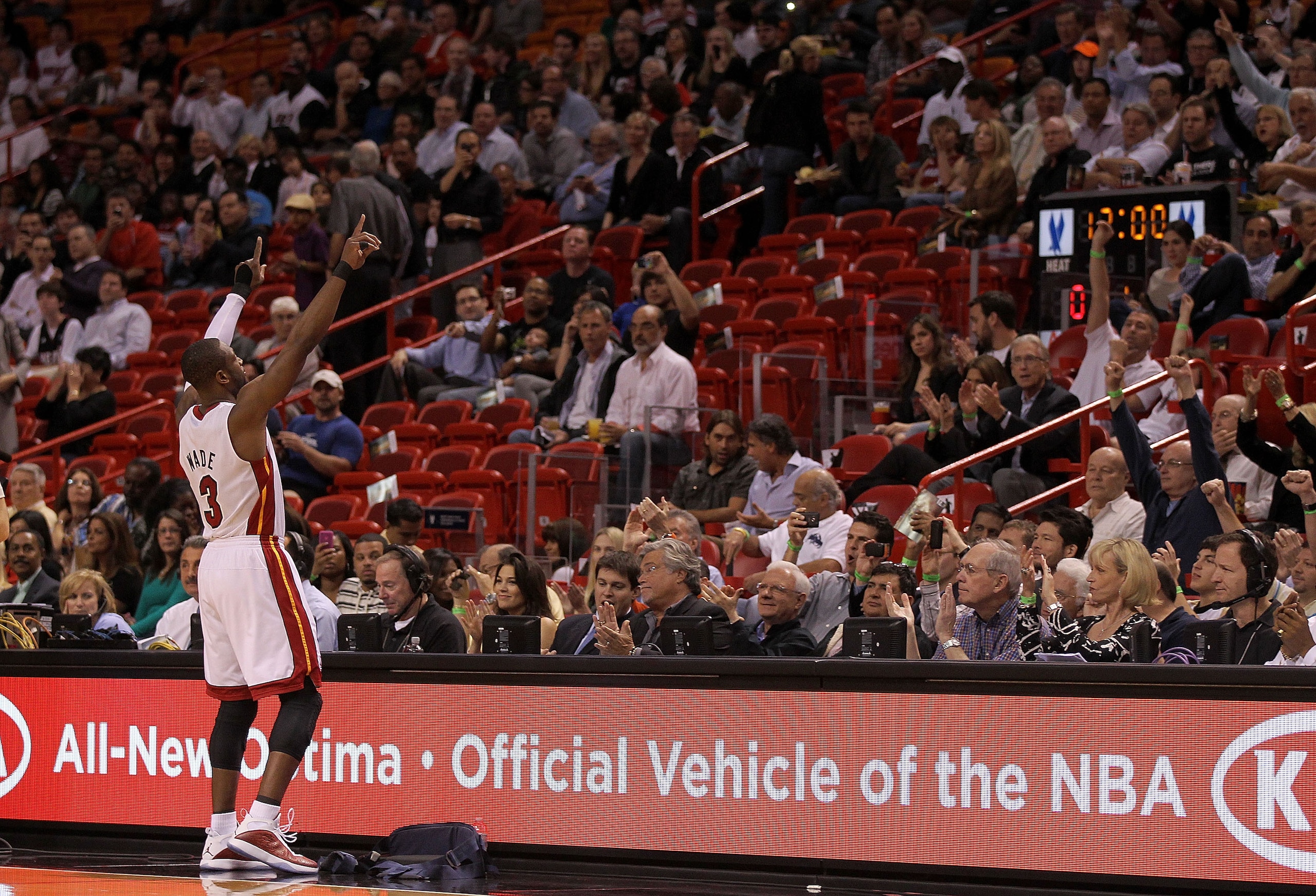 MIAMI, FL - JANUARY 31:  Dwyane Wade #3 of the Miami Heat greets fans during a game against the Cleveland Cavaliers at American Airlines Arena on January 31, 2011 in Miami, Florida. NOTE TO USER: User expressly acknowledges and agrees that, by downloading