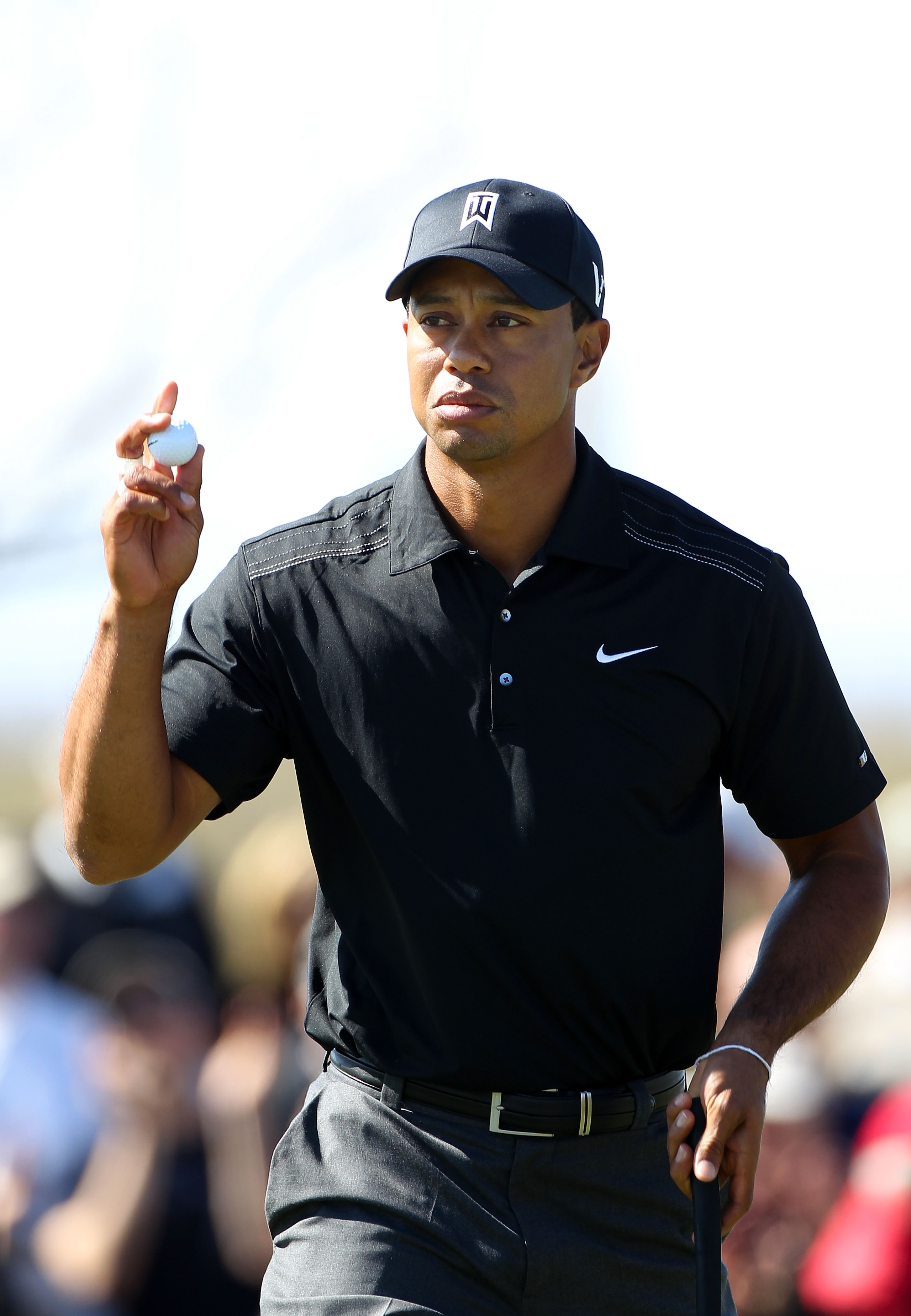 MARANA, AZ - FEBRUARY 23: Tiger Woods waves to fans after making his putt on the seventh hole during the first round of the Accenture Match Play Championship at the Ritz-Carlton Golf Club on February 23, 2011 in Marana, Arizona.  (Photo by Sam Greenwood/G
