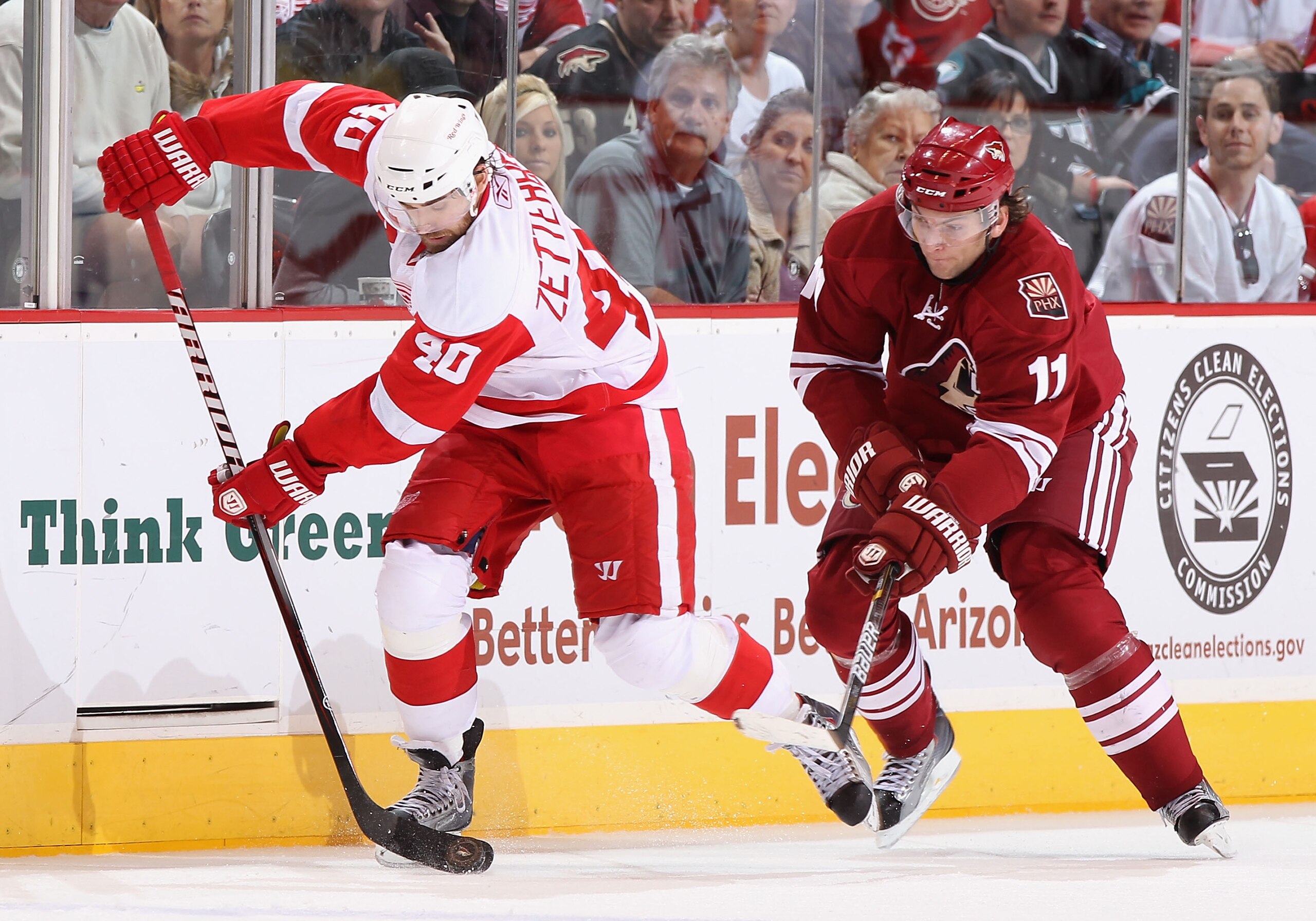 GLENDALE, AZ - MARCH 05:  Henrik Zetterberg #40 of the Detroit Red Wings skates with the puck past Martin Hanzal #11 of the Phoenix Coyotes during the NHL game at Jobing.com Arena on March 5, 2011 in Glendale, Arizona. The Coyotes defeated the Red Wings 5