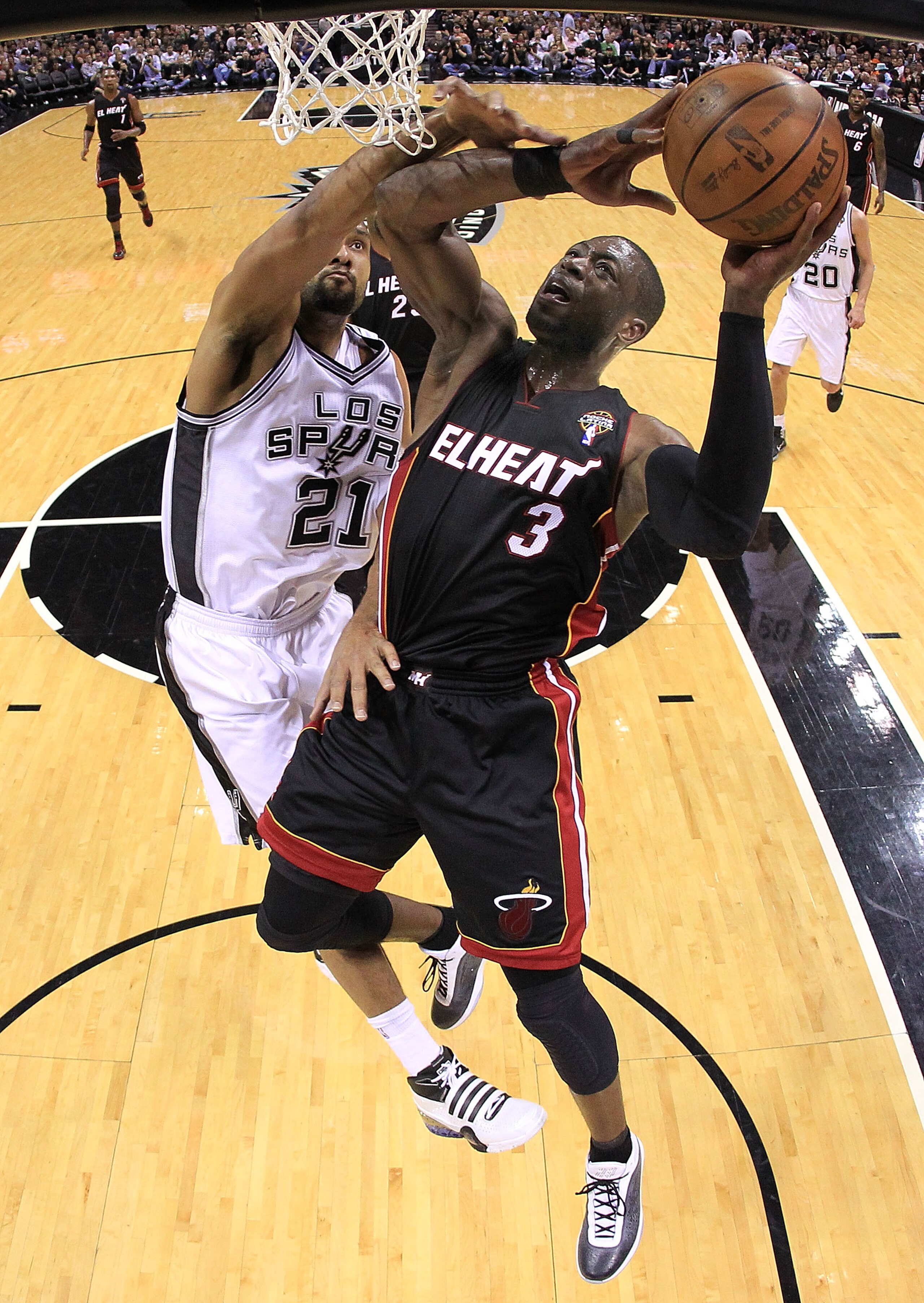 SAN ANTONIO, TX - MARCH 04:  Guard Dwyane Wade #3 of the Miami Heat takes a shot against Tim Duncan #21 of the San Antonio Spurs at AT&T Center on March 4, 2011 in San Antonio, Texas.   NOTE TO USER: User expressly acknowledges and agrees that, by downloa