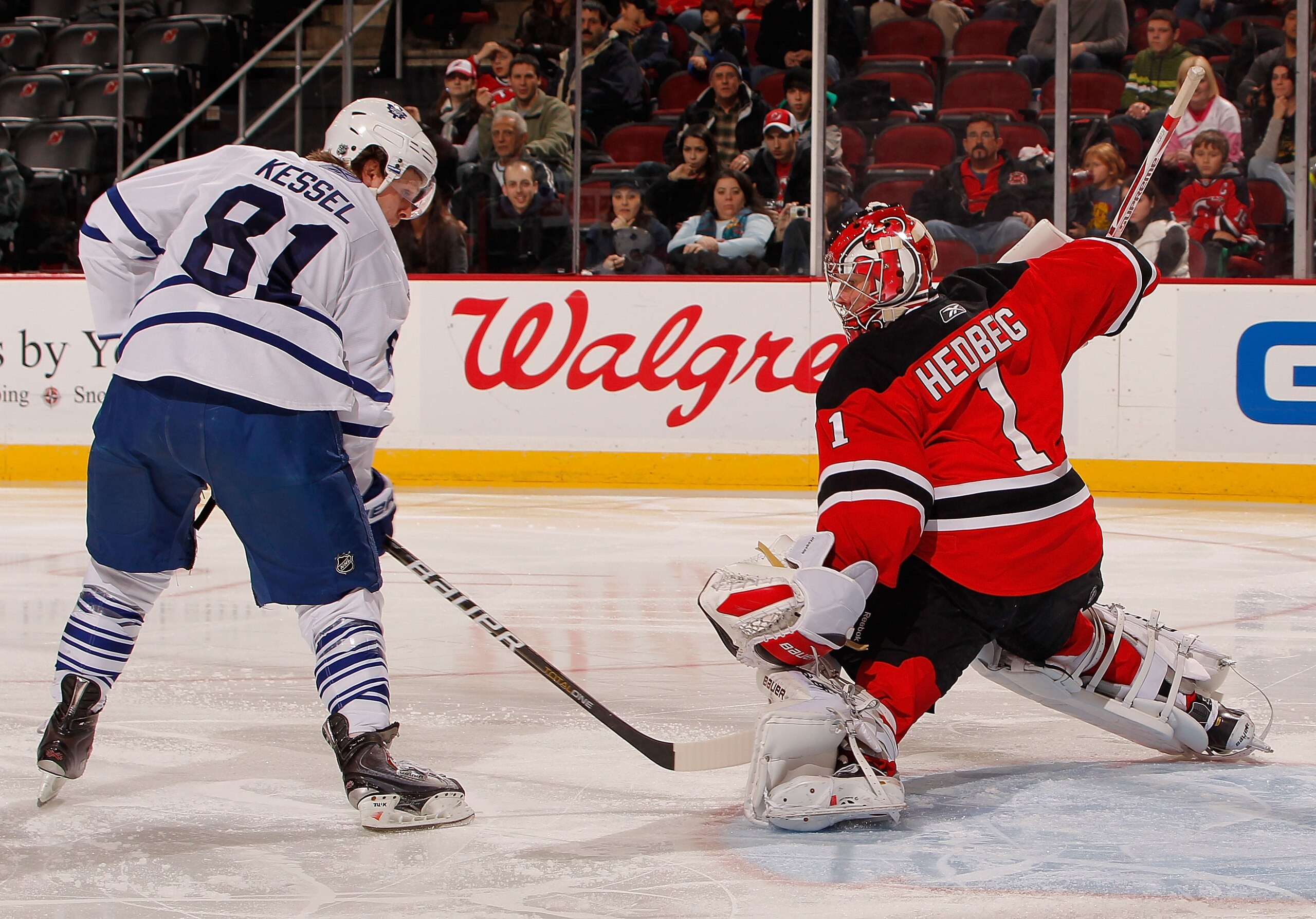 NEWARK, NJ - DECEMBER 26: Phil Kessel #81 of the Toronto Maple Leafs is stopped on this tip in attempt by Johan Hedberg #1 of the New Jersey Devils in the third period of an NHL hockey game at the Prudential Center on December 26, 2010 in Newark, New Jer NEWARK, NJ - DECEMBER 26: Phil Kessel #81 of the Toronto Maple Leafs is stopped on this tip in attempt by Johan Hedberg #1 of the New Jersey Devils in the third period of an NHL hockey game at the Prudential Center on December 26, 2010 in Newark, New Jer