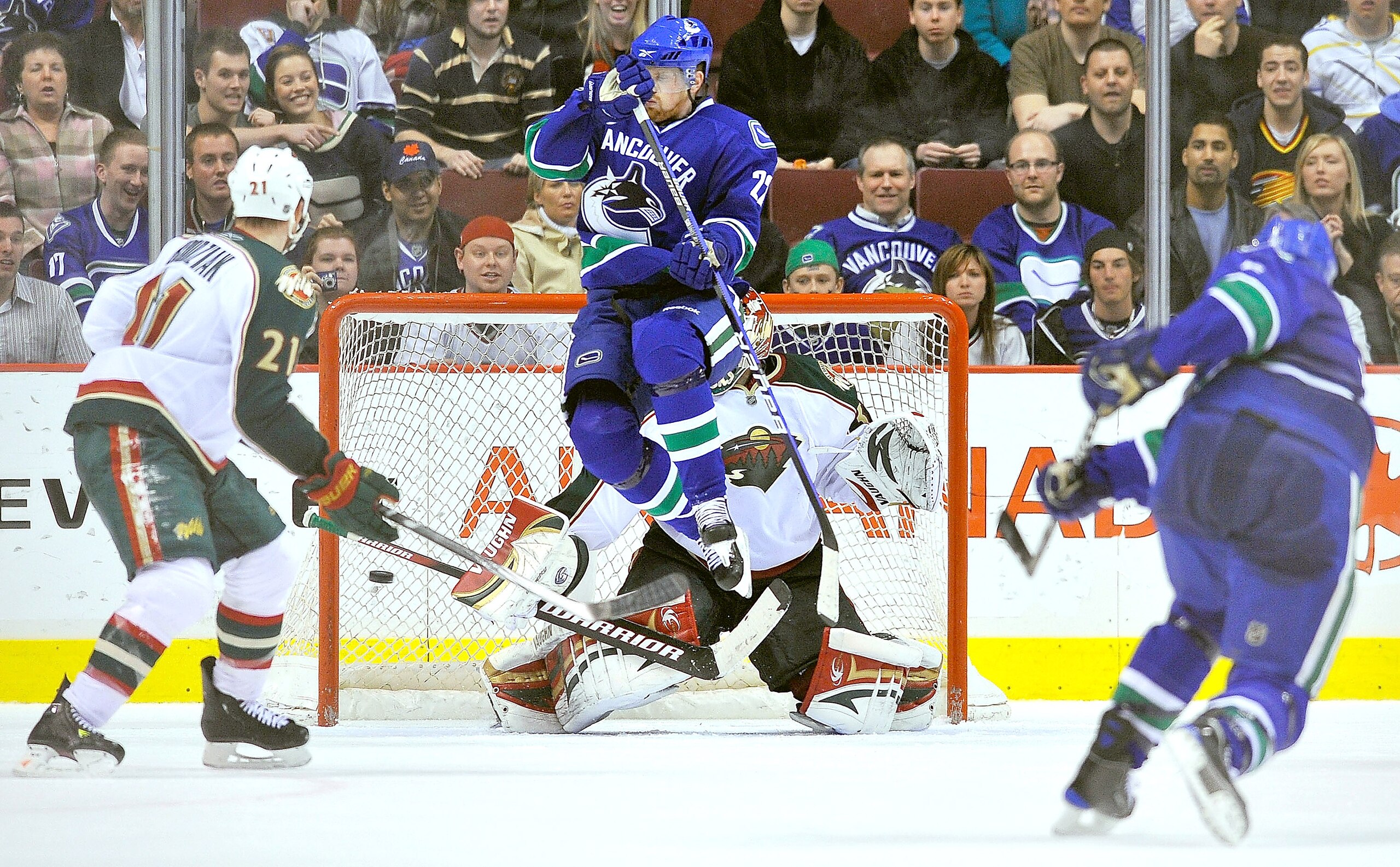 VANCOUVER, CANADA - APRIL 4: Daniel Sedin #22 of the Vancouver Canucks jumps out of the way of teammate Sami Salo's #6 shot as it find the back of the net past goalie Niklas Backstrom #32 of the Minnesota Wild during the overtime period of NHL action on A VANCOUVER, CANADA - APRIL 4: Daniel Sedin #22 of the Vancouver Canucks jumps out of the way of teammate Sami Salo's #6 shot as it find the back of the net past goalie Niklas Backstrom #32 of the Minnesota Wild during the overtime period of NHL action on A