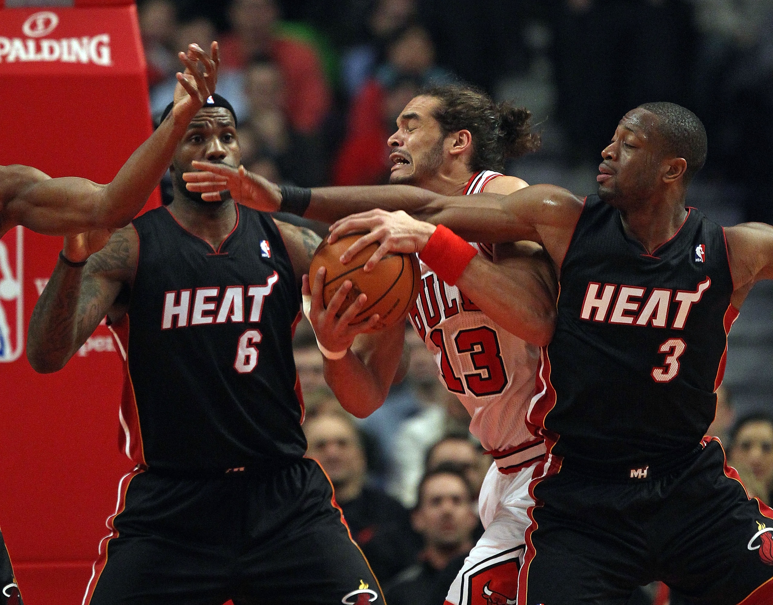 CHICAGO, IL - FEBRUARY 24: Joakim Noah #13 of the Chicago Bulls battles for control of the ball with LeBron James #6 and Dwyane Wade #3 of the Miami Heat at the United Center on February 24, 2011 in Chicago, Illinois. NOTE TO USER: User expressly acknowle