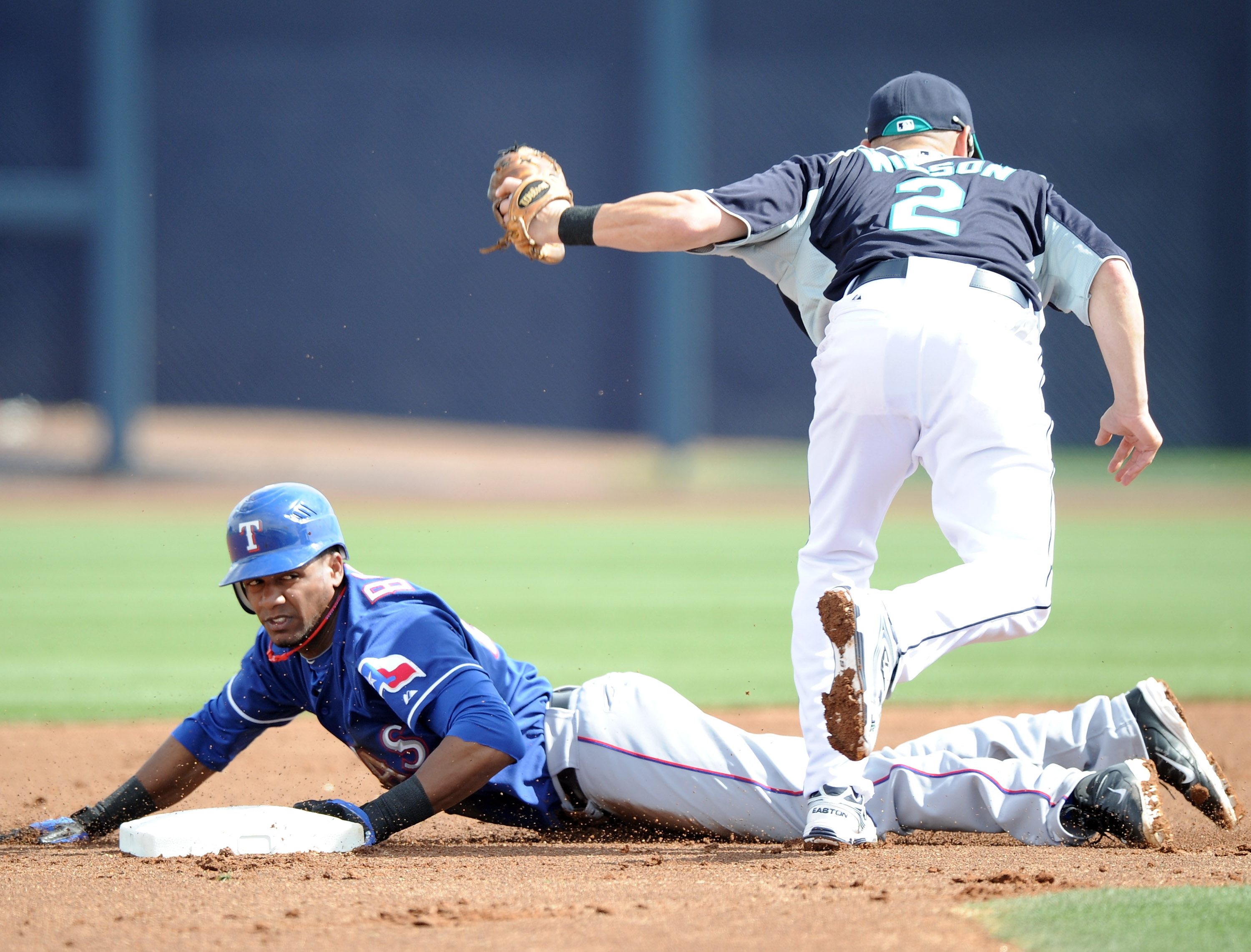 PEORIA, AZ - MARCH 01:  Julio Borbon #20 of the Texas Rangers is caught stealing by Jack Wilson #20 of the Seattle Mariners in the first inning during spring training at Peoria Stadium on March 1, 2011 in Peoria, Arizona.  (Photo by Harry How/Getty Images