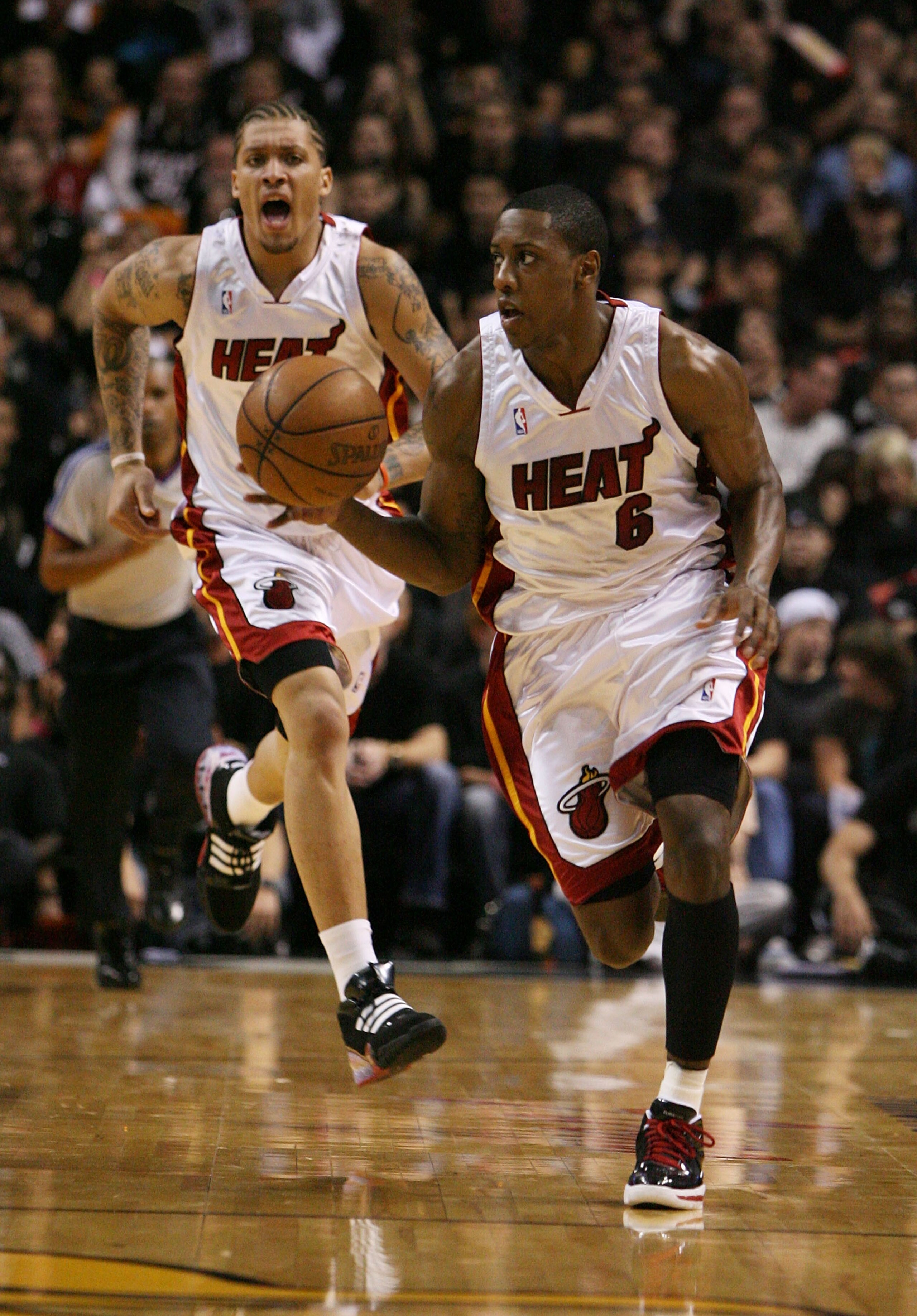 MIAMI - MAY 01:  Mario Chalmers #6 of the Miami Heat brings the ball into the front court followed by teammate Michael Beasley #30 while taking on the Atlanta Hawks during Game Six of the Eastern Conference Quarterfinals at American Airlines Arena on May 