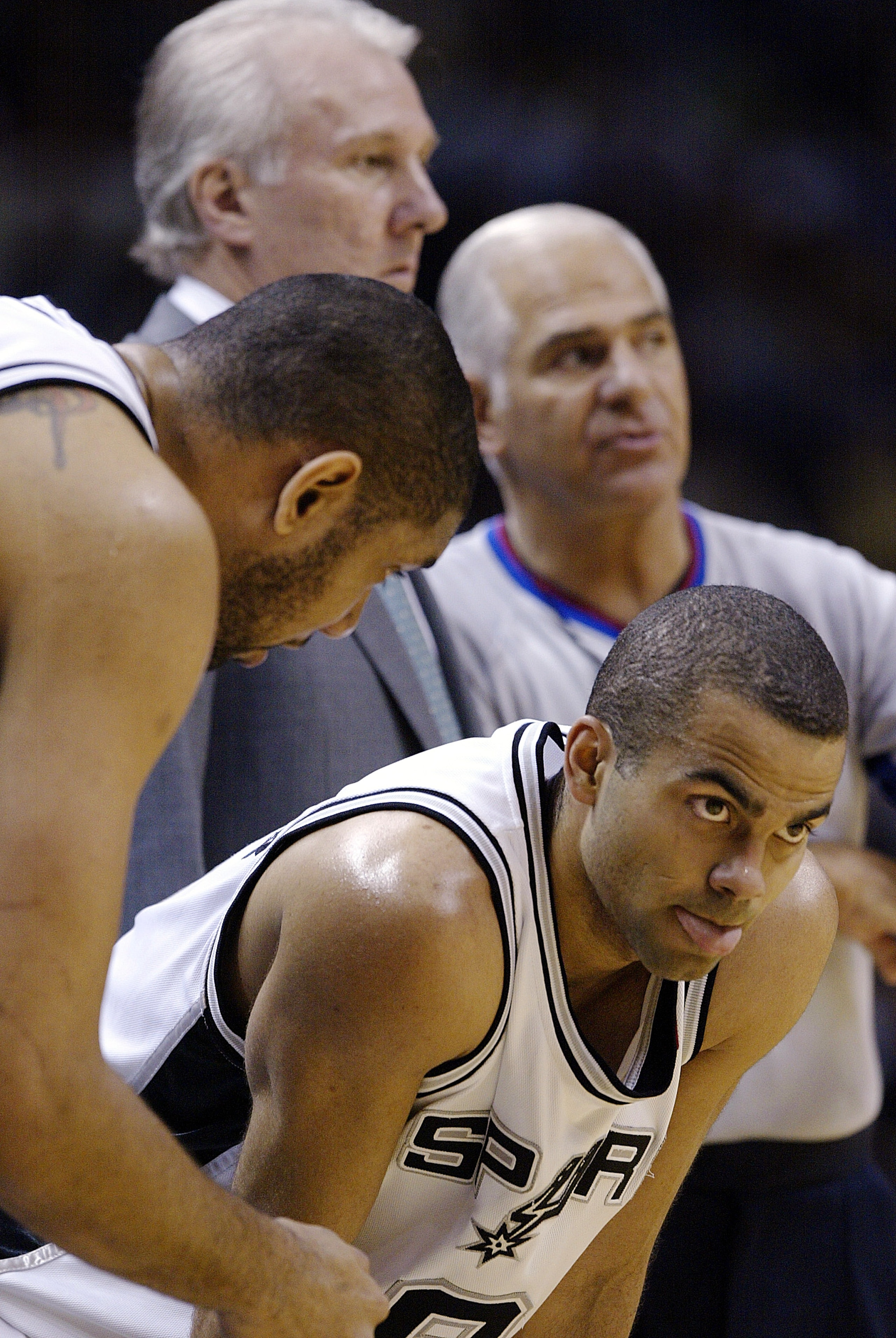 SAN ANTONIO - MAY 8:  Tim Duncan #21 of the San Antonio Spurs talks with teammate Tony Parker #9 while their head coach Gregg Popovich talks with referee Derrick Stafford #15 during a break in play against Seattle SuperSonics in Game one of the Western Co