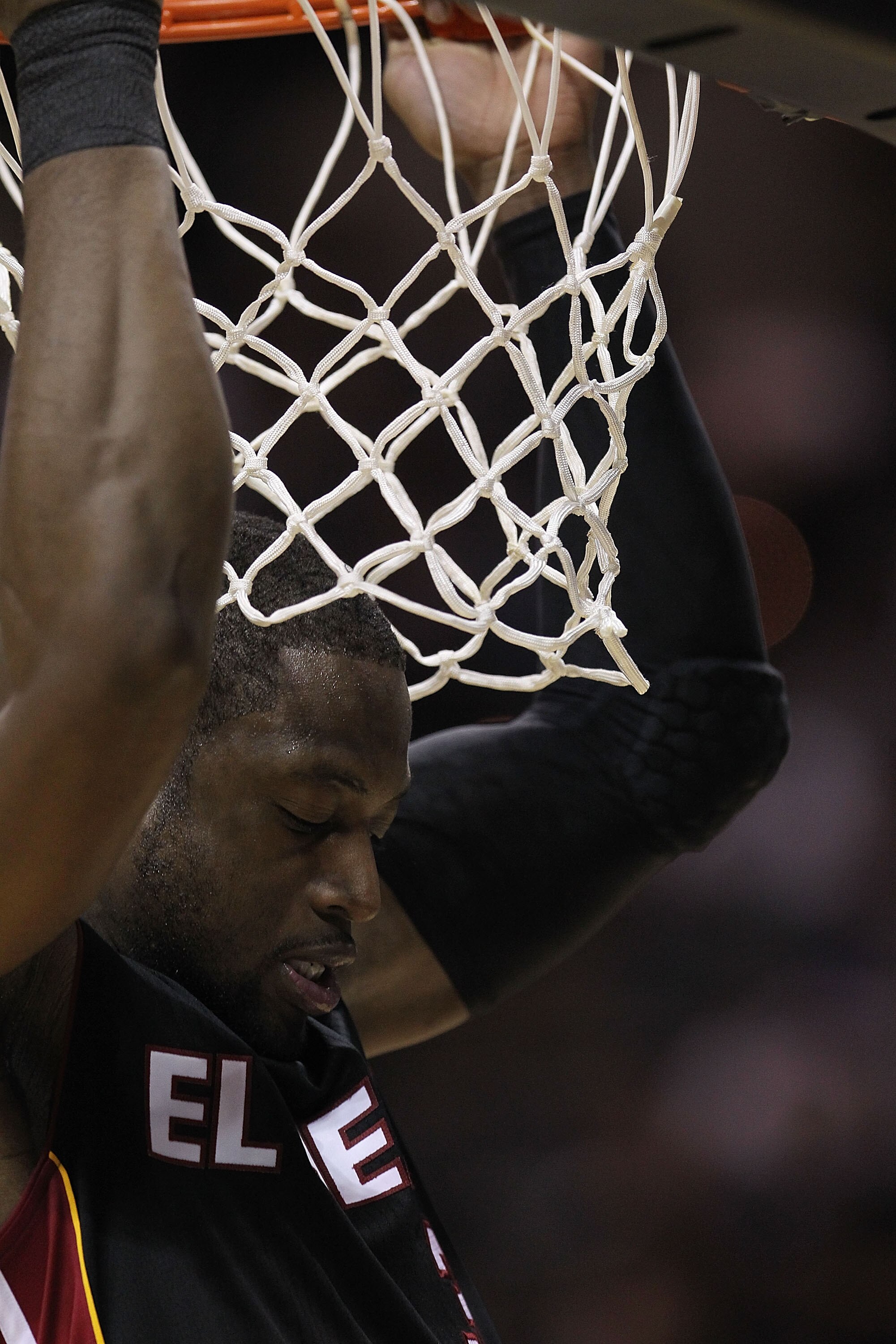 SAN ANTONIO, TX - MARCH 04:  Guard Dwyane Wade #3 of the Miami Heat hangs on the rim before a game against the San Antonio Spurs at AT&T Center on March 4, 2011 in San Antonio, Texas.   NOTE TO USER: User expressly acknowledges and agrees that, by downloa