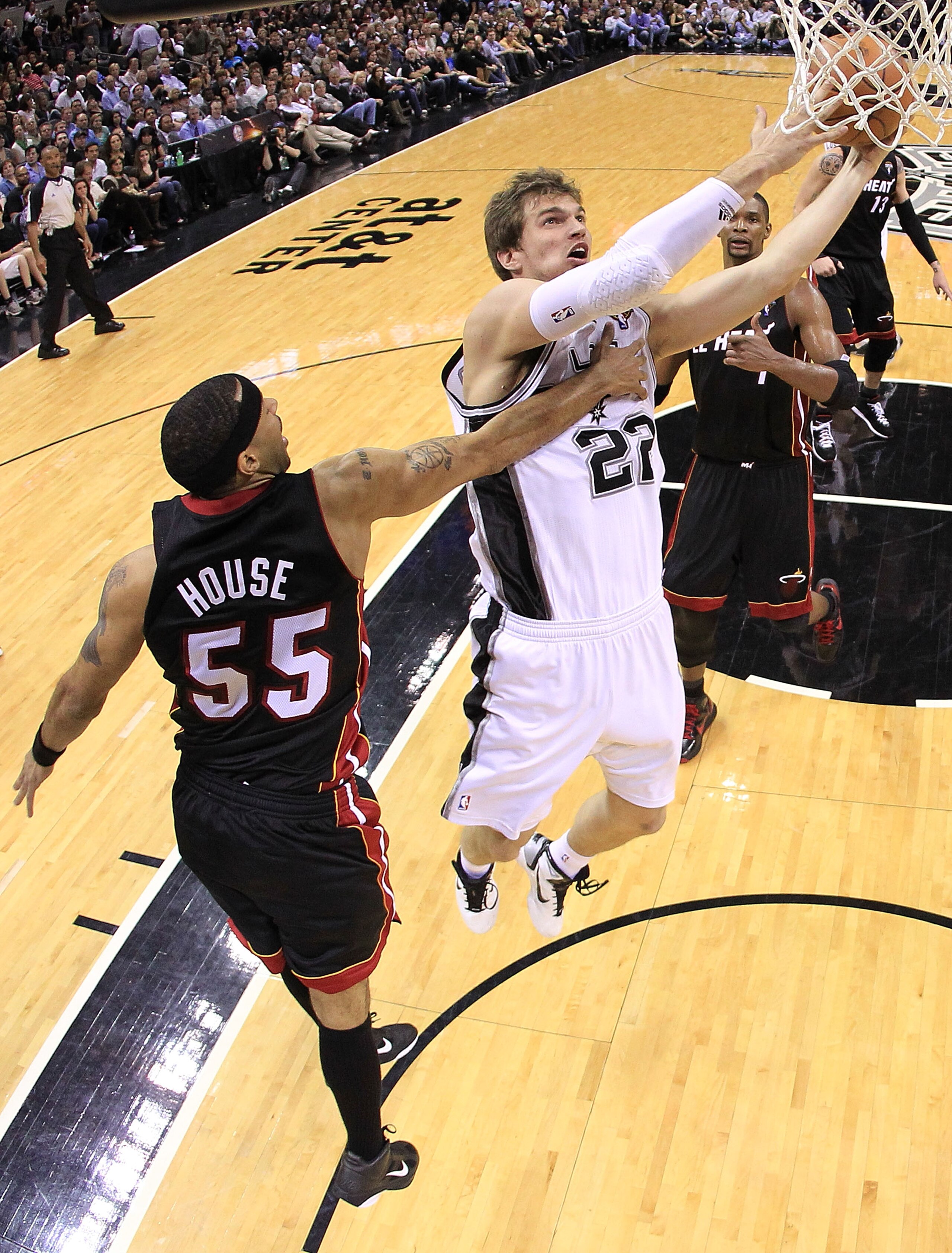 SAN ANTONIO, TX - MARCH 04:  Forward Tiago Splitter #22 of the San Antonio Spurs takes a shot against Eddie House #55 of the Miami Heat at AT&T Center on March 4, 2011 in San Antonio, Texas.   NOTE TO USER: User expressly acknowledges and agrees that, by