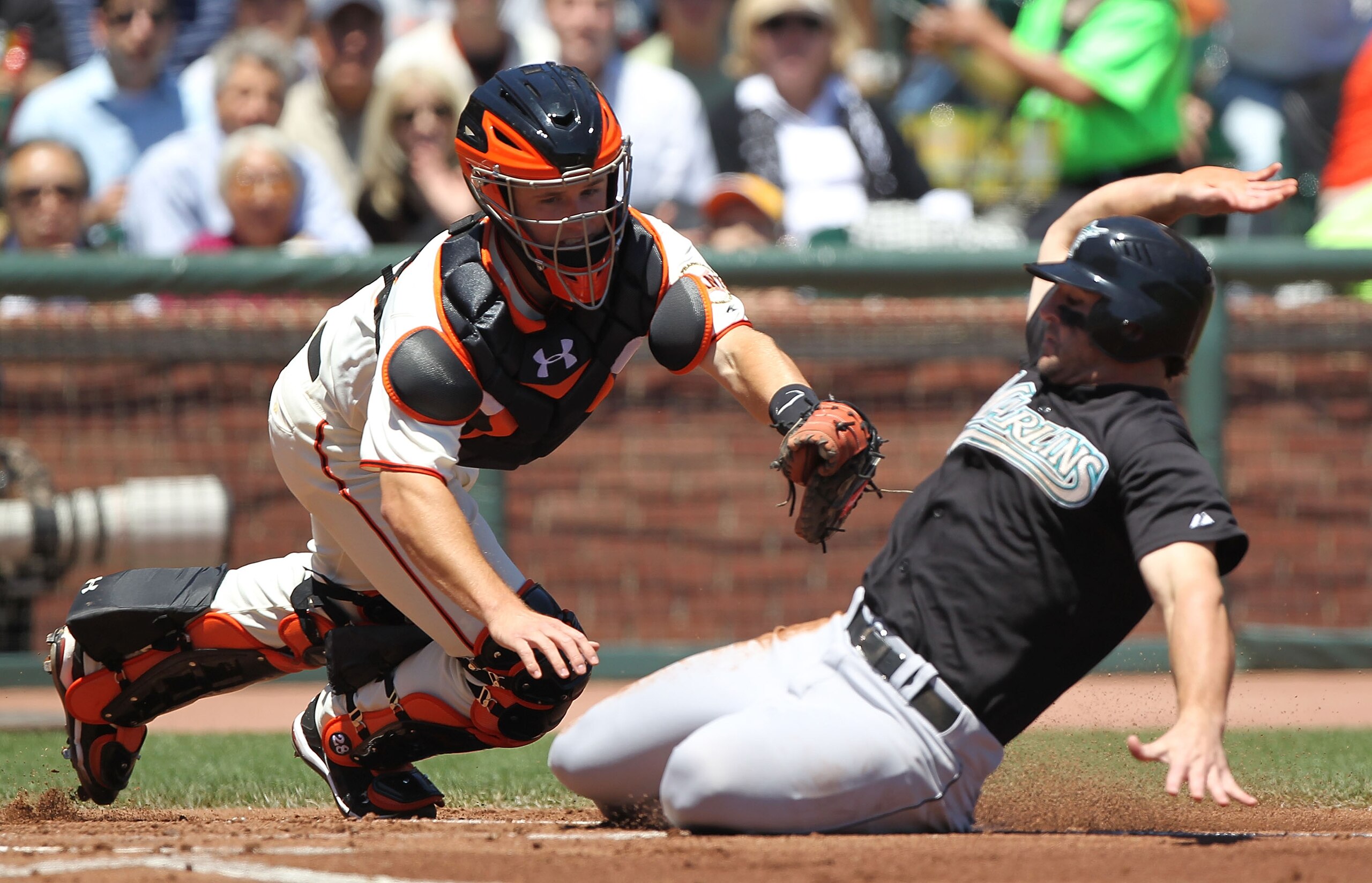 SAN FRANCISCO - JULY 29: Buster Posey #28 of the San Francisco Giants fails to tag our Dan Uggla #6 of the Florida Marlins on a double hit by Mike Stanton #27 in the second inning during an MLB game at AT&T Park on July 29, 2010 in San Francisco, Californ
