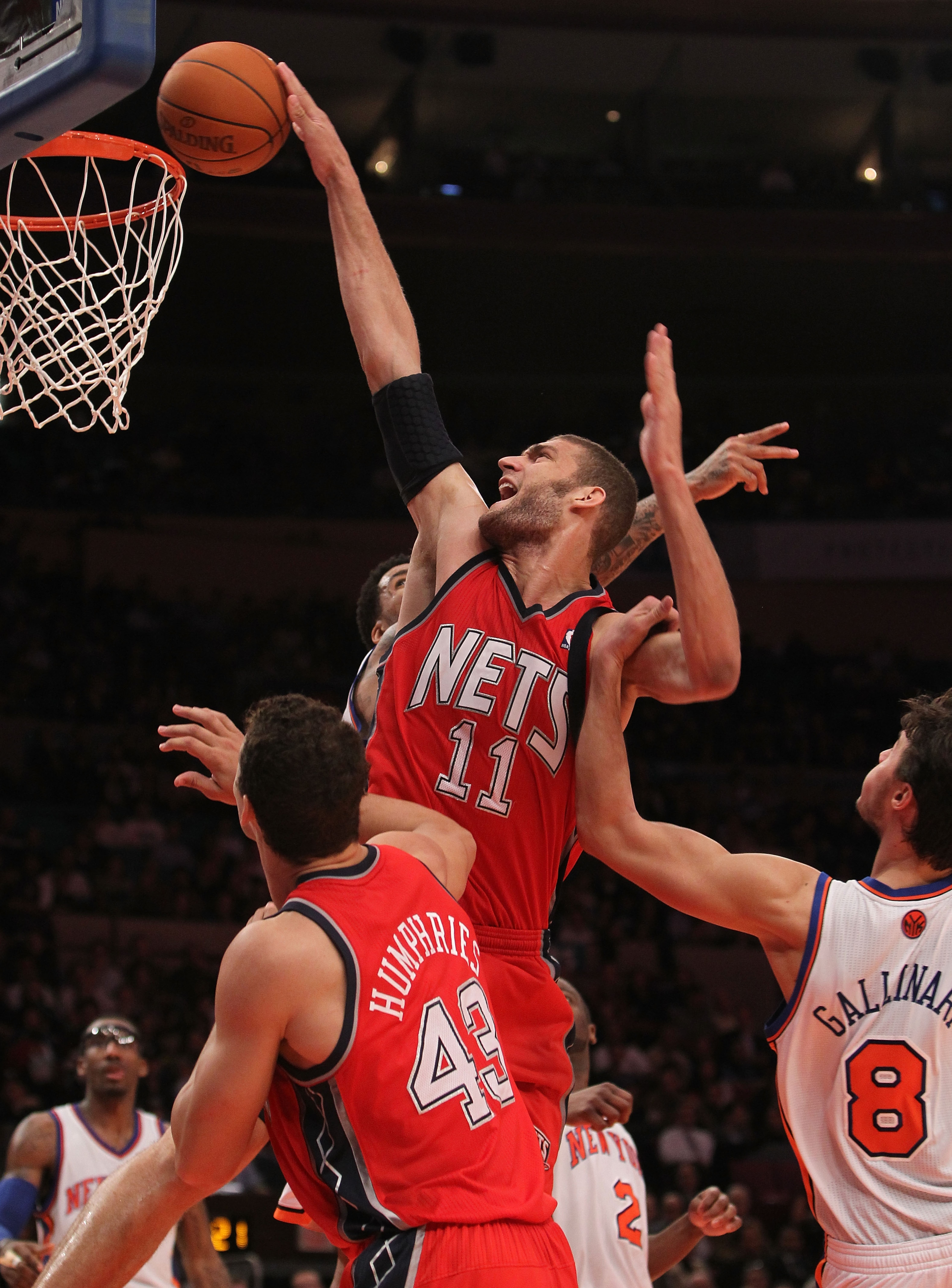 NEW YORK, NY - NOVEMBER 30: Brook Lopez #11 of the of the New Jersey Nets is fouled by Danilo Gallinari #8 of the New York Knicks on November 30, 2010 at Madison Square Garden in New York City. NOTE TO USER: User expressly acknowledges and agrees that, by