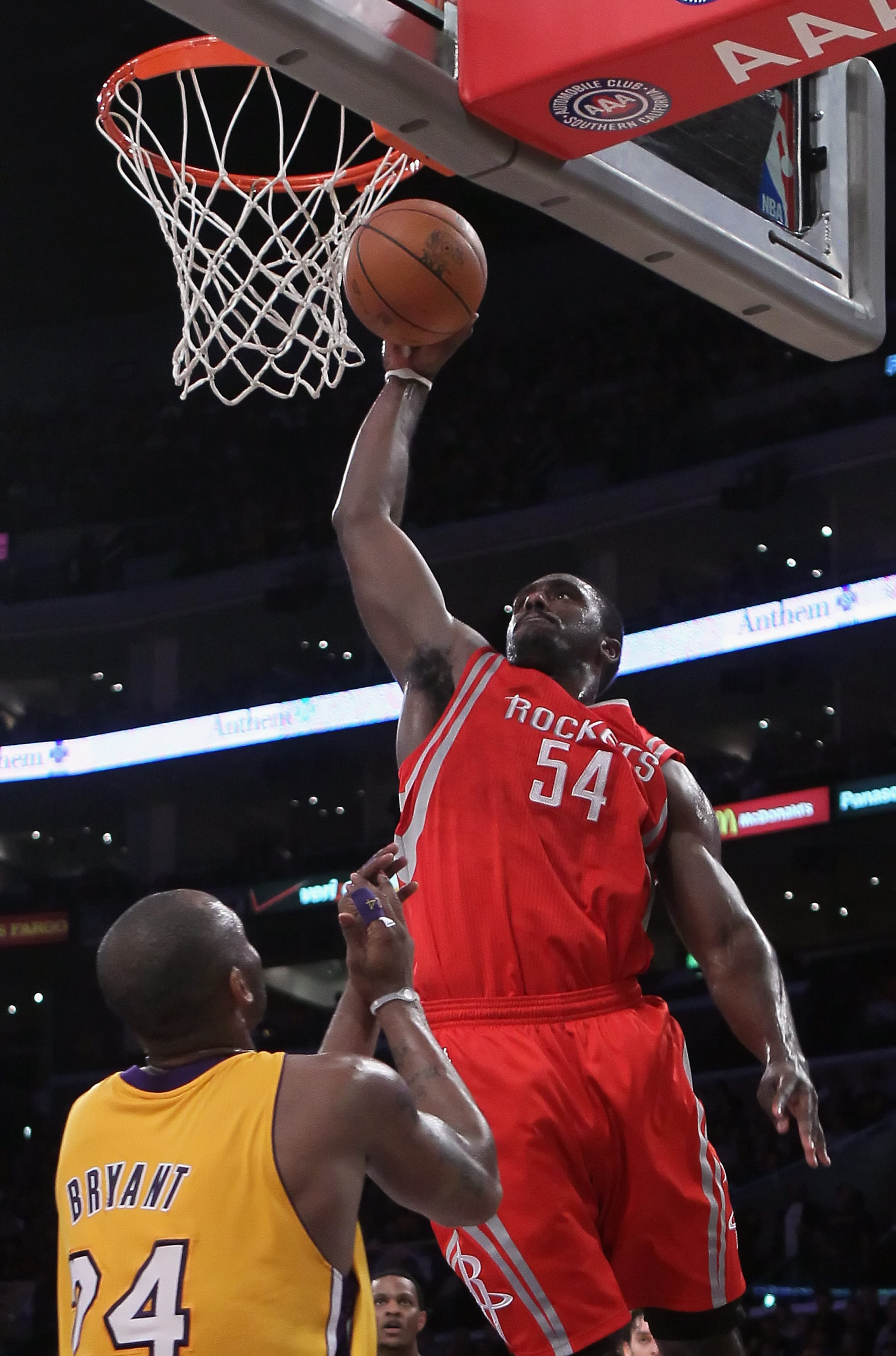 LOS ANGELES, CA - FEBRUARY 01:  Patrick Patterson #54 of the Houston Rockets drives over Kobe Bryant #24 of the Los Angeles Lakers for a dunk in the first half at Staples Center on February 1, 2011 in Los Angeles, California. NOTE TO USER: User expressly