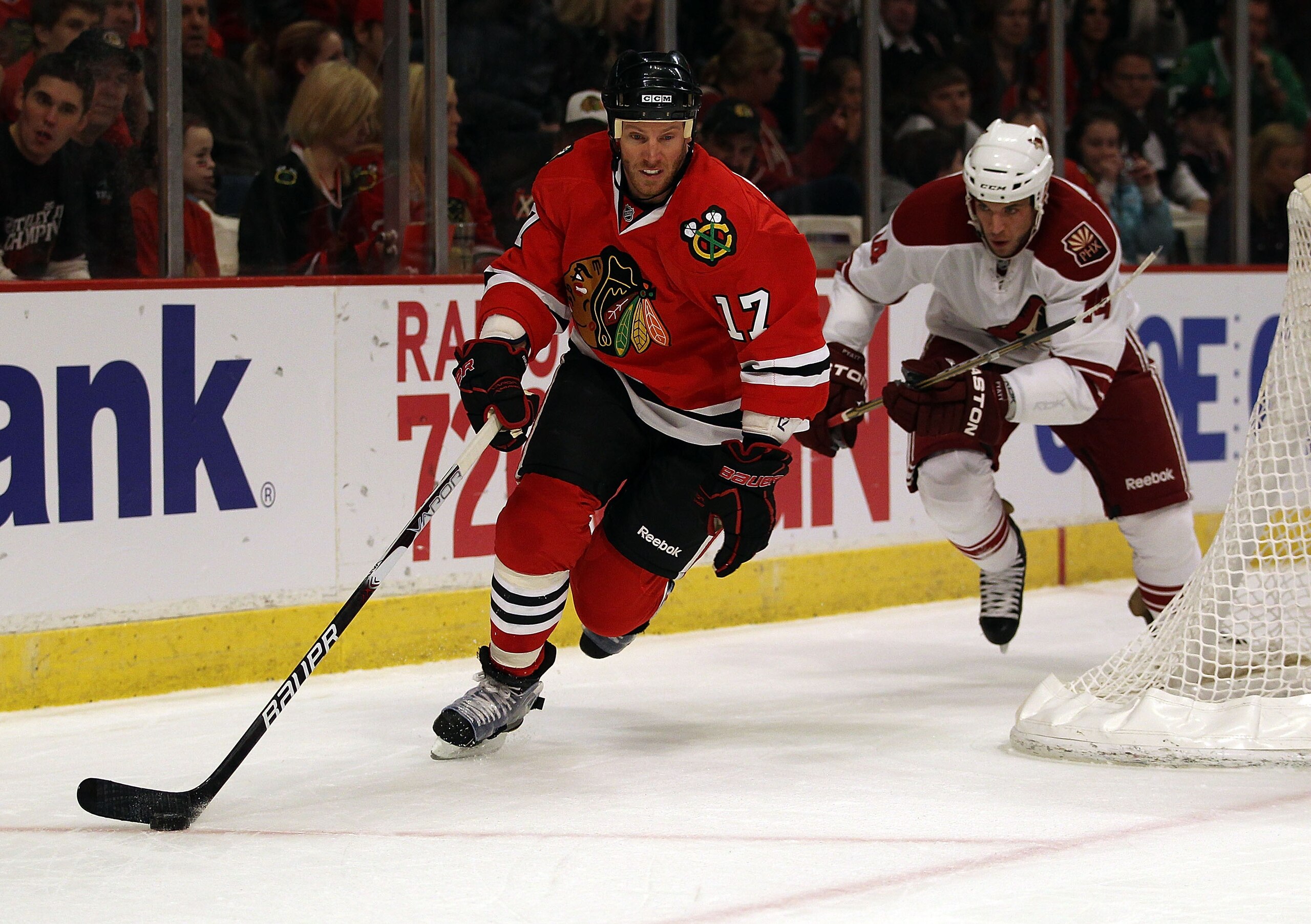CHICAGO, IL - FEBRUARY 27: Ryan Johnson #17 of the Chicago Blackhawks controls the puck in front of Taylor Pyatt #14 of the Phoenix Coyotes at the United Center on February 27, 2011 in Chicago, Illinois. The Blackhawks defeated the Coyotes 4-3 in a shooto