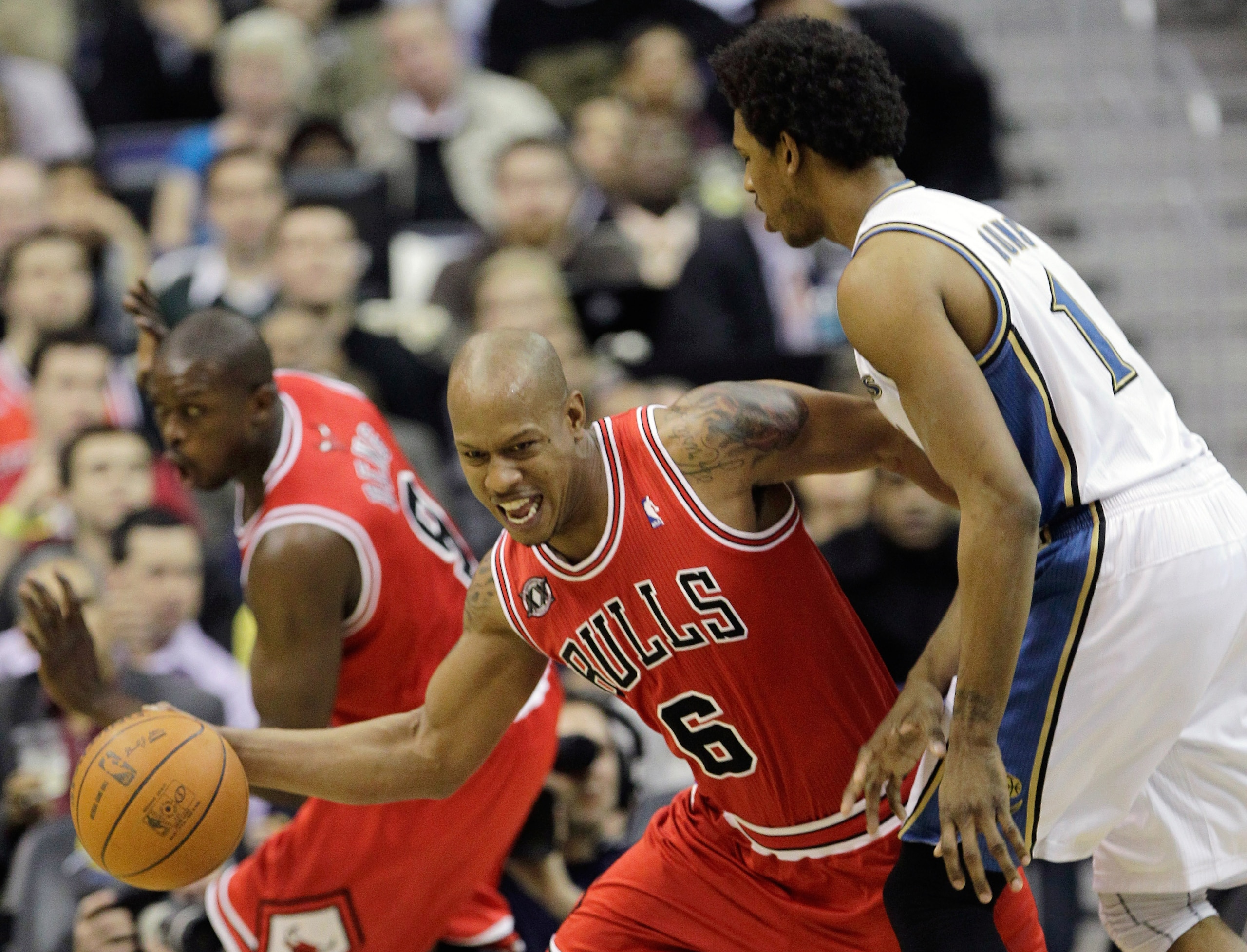 WASHINGTON, DC - FEBRUARY 28:  Keith Bogans #6 of the Chicago Bulls pulls in a rebound in front of Nick Young #1 of the Washington Wizards at the Verizon Center in Washington on February 28, 2011 in Washington, DC. NOTE TO USER: User expressly acknowledge
