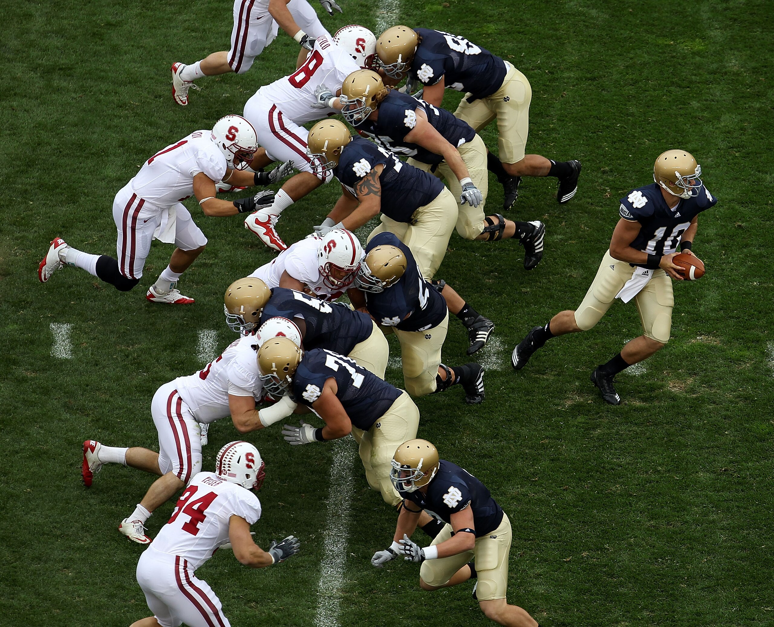 SOUTH BEND, IN - SEPTEMBER 25: Dayne Crist #10 of the Notre Dame Fighting Irish turns to hand-off as his offensive line blocks against the Stanford Cardinal defense at Notre Dame Stadium on September 25, 2010 in South Bend, Indiana. Standford defeated Not