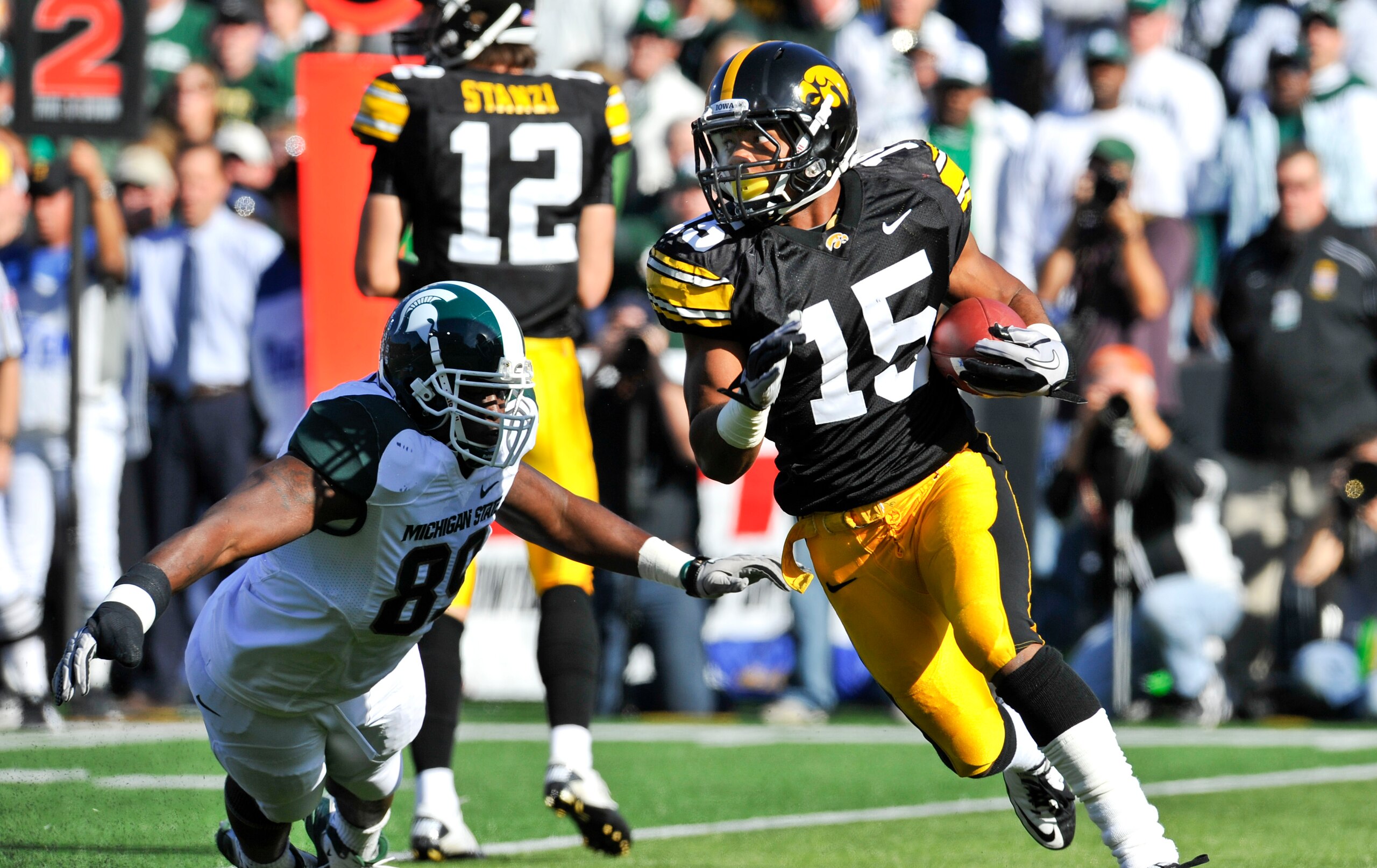 IOWA CITY, IA - OCTOBER 30: Wide reciver Derrell Johnson-Koulianos #15 of the University of Iowa Hawkeyes runs the ball past defensive end Colin Neely #89 of the Michigan State Spartans during the first half of play at Kinnick Stadium on October 30, 2010 IOWA CITY, IA - OCTOBER 30: Wide reciver Derrell Johnson-Koulianos #15 of the University of Iowa Hawkeyes runs the ball past defensive end Colin Neely #89 of the Michigan State Spartans during the first half of play at Kinnick Stadium on October 30, 2010
