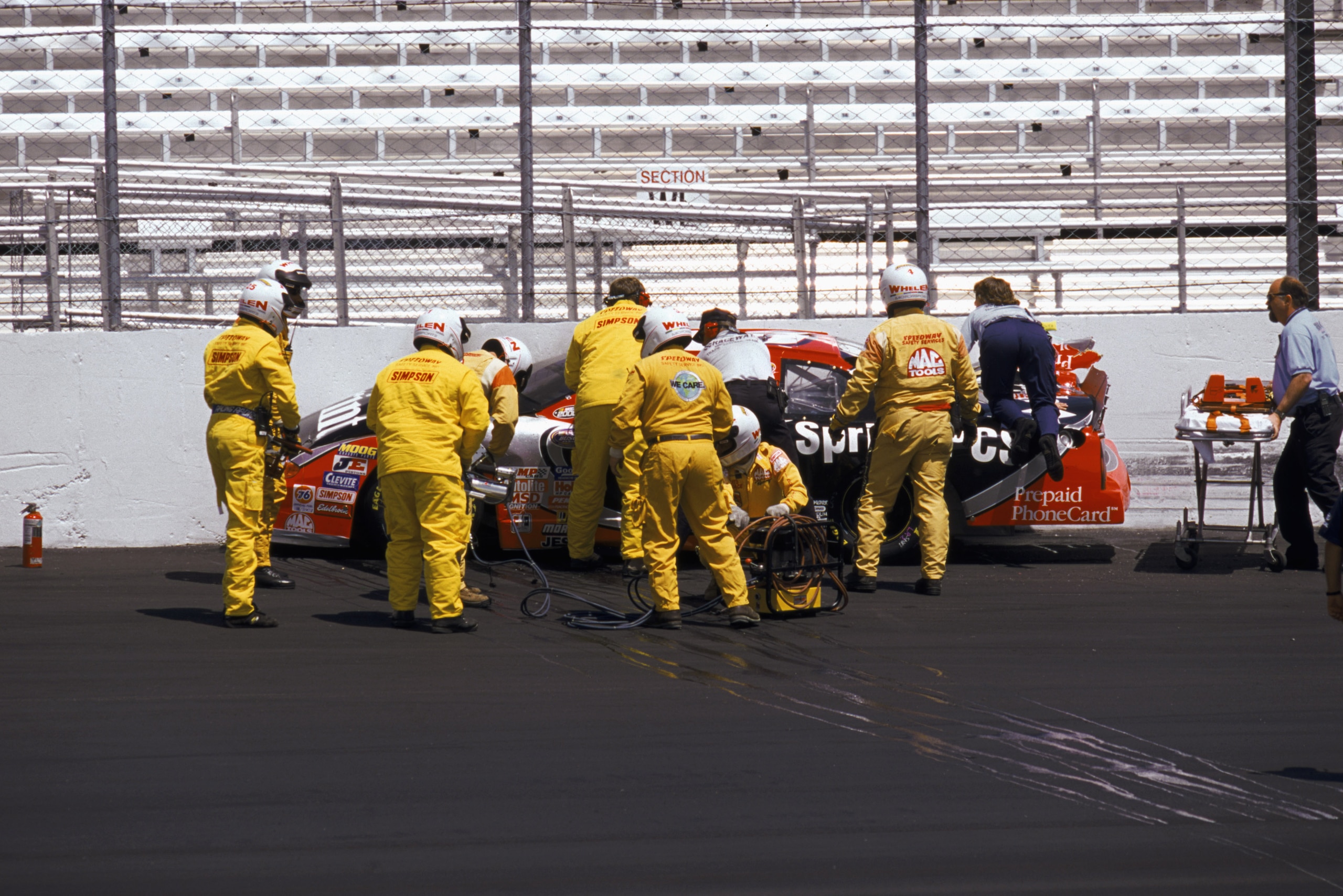 LOUDON, NH - MAY 12:  E.M.T. and firefighters attend to #45 Adam Petty and his car after Petty spun-out and crashed into a concrete barrier during practice for the Busch 200, part of the NASCAR Busch Series at the New Hampshire International Speedway in L