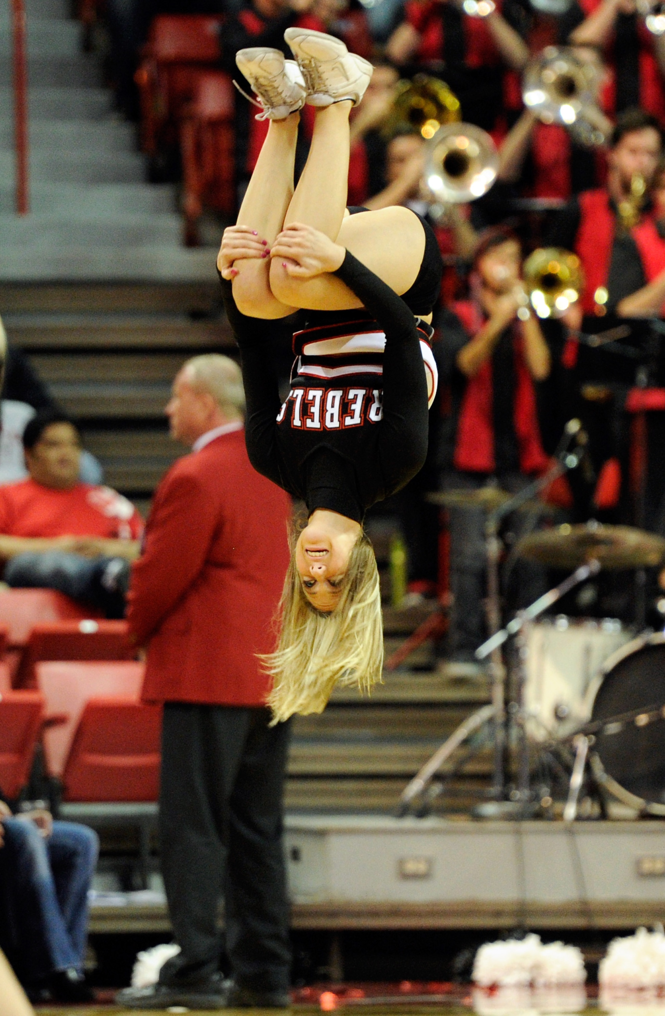 LAS VEGAS, NV - FEBRUARY 15:  A UNLV Rebels cheerleader flips in the air during a game against the Air Force Falcons at the Thomas & Mack Center February 15, 2011 in Las Vegas, Nevada. UNLV won 49-42.  (Photo by Ethan Miller/Getty Images)