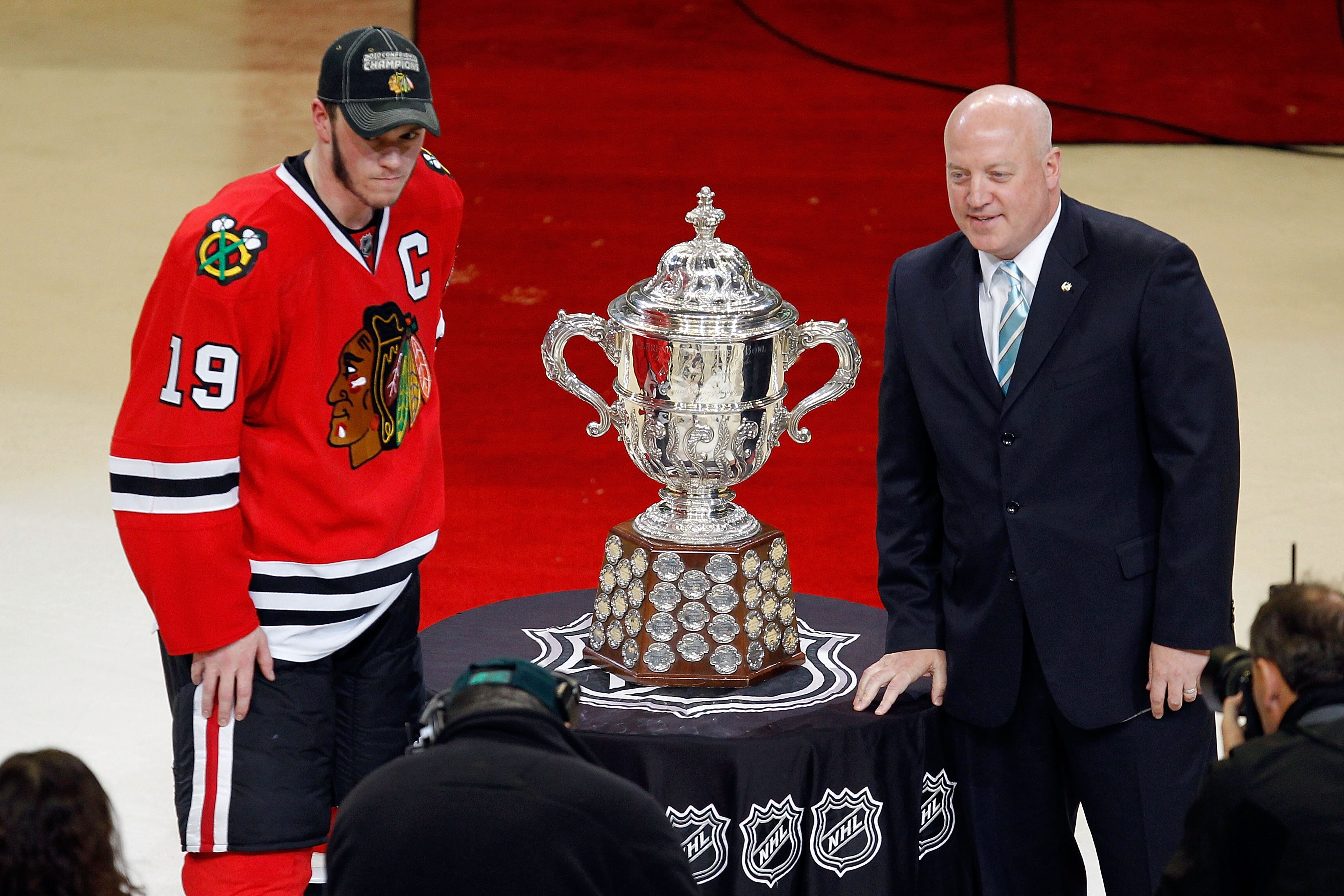 CHICAGO - MAY 23:  Jonathan Toews #19 of the Chicago Blackhawks poses with National Hockey League Deputy Commissioner Bill Daly as Toews receives the Campbell Trophy for winning the Western Conference after the Blackhawks 4-2 victory in Game Four of the W