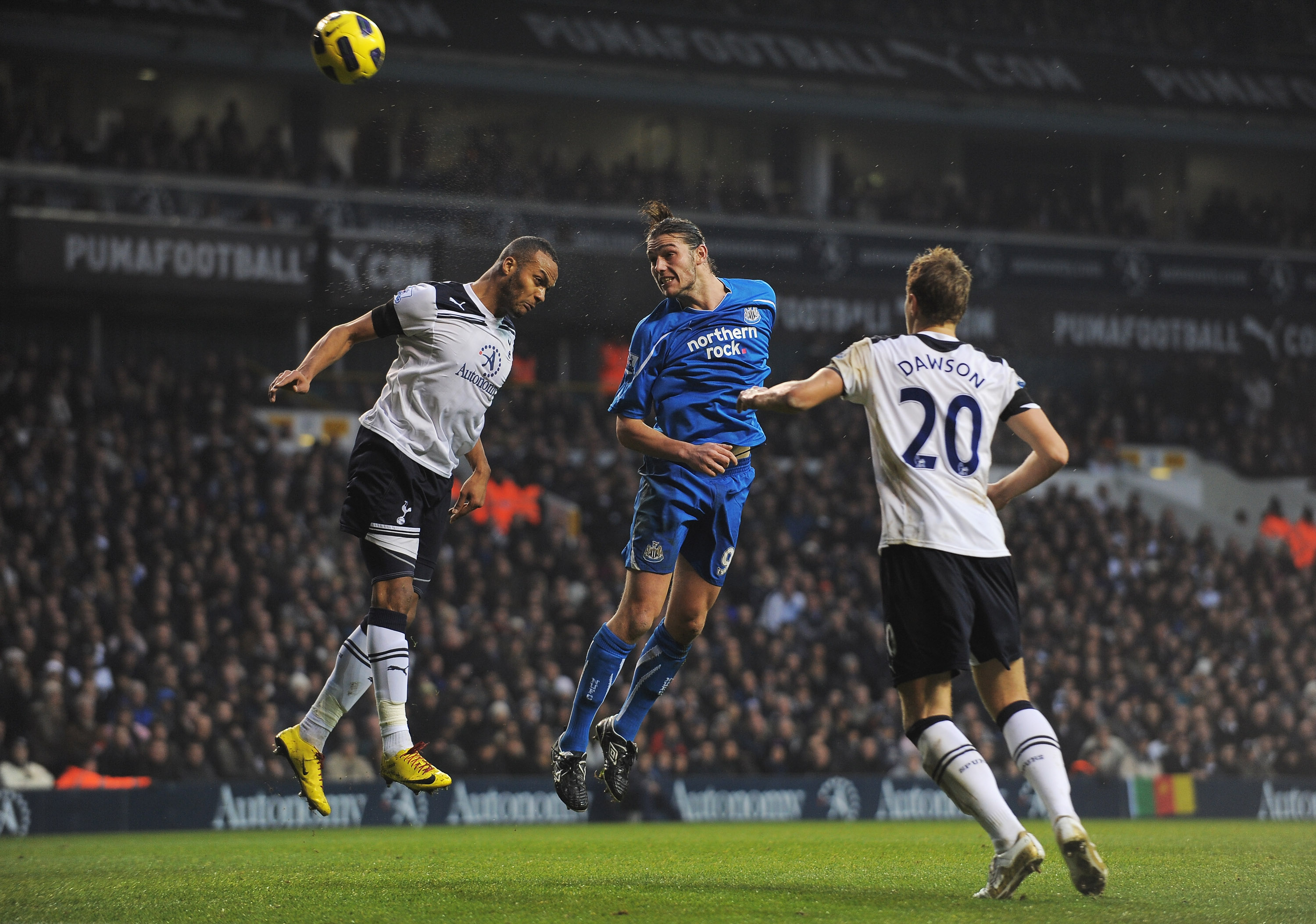 LONDON, ENGLAND - DECEMBER 28:  Andy Carroll of Newcastle United wins a header against Younes Kaboul of Tottenham Hotspur during the Barclays Premier League match between Tottenham Hotspur and Newcastle United at White Hart Lane on December 28, 2010 in Lo