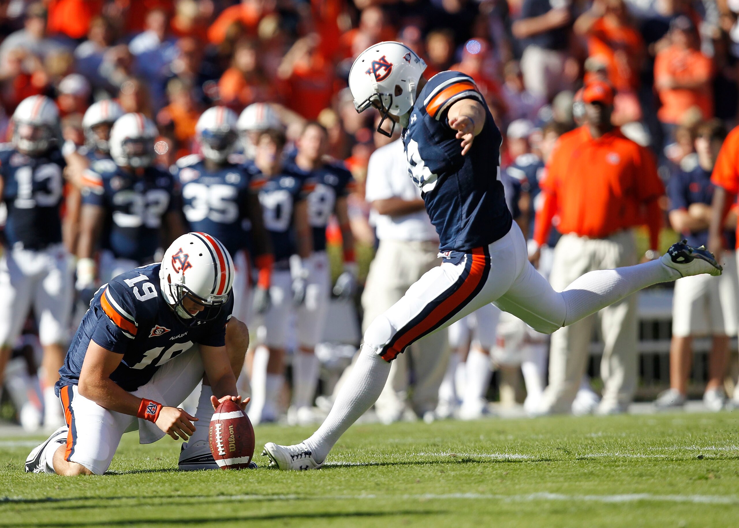 AUBURN - OCTOBER 16: Field goal kicker Wes Byrum #18 of the Auburn Tigers prepares to kick a field goal in the second quarter while Neil Caudle #19 holds the ball during the game against the Arkansas Razorbacks at Jordan-Hare Stadium on October 16, 2010 AUBURN - OCTOBER 16: Field goal kicker Wes Byrum #18 of the Auburn Tigers prepares to kick a field goal in the second quarter while Neil Caudle #19 holds the ball during the game against the Arkansas Razorbacks at Jordan-Hare Stadium on October 16, 2010