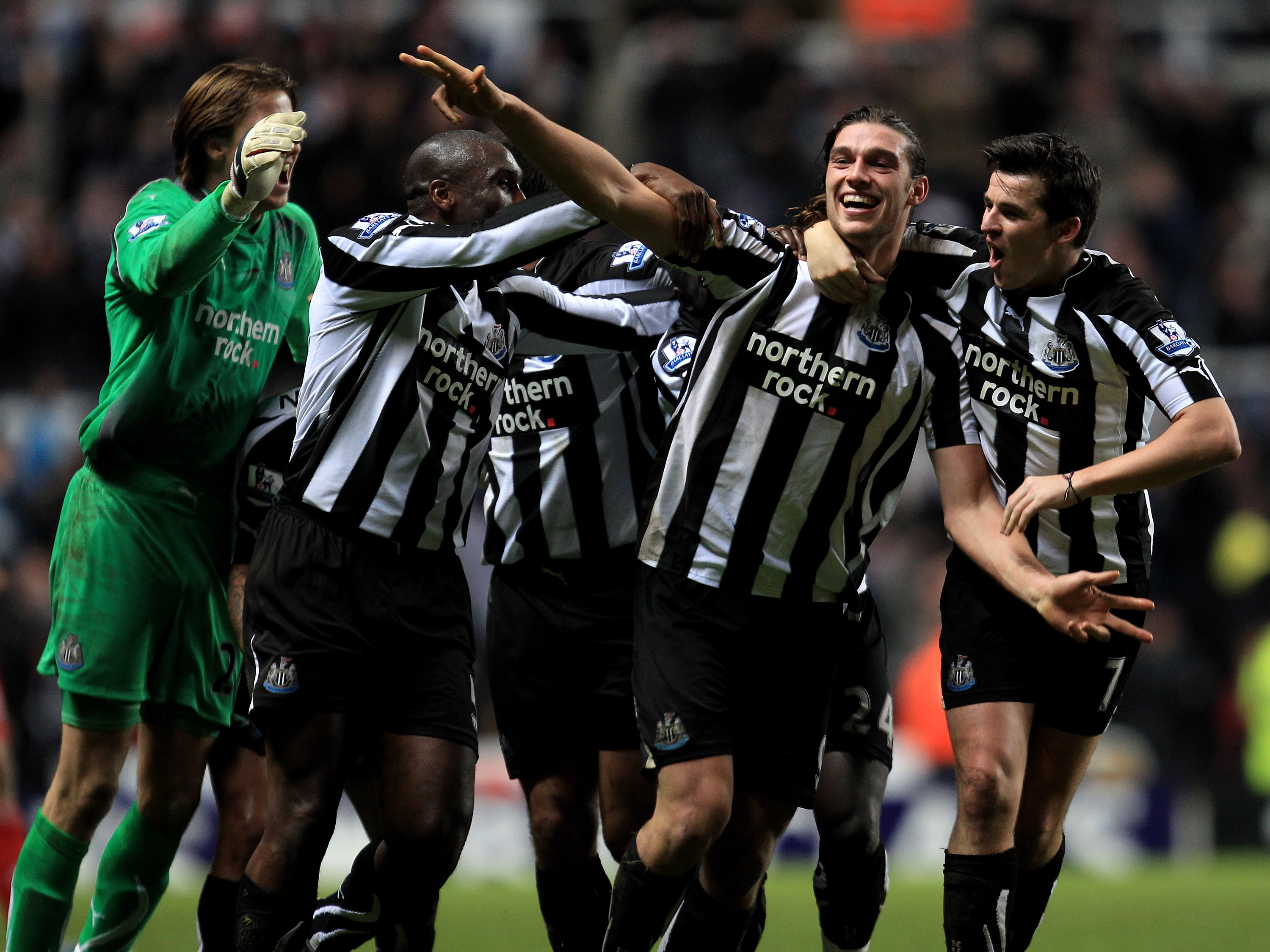 NEWCASTLE UPON TYNE, ENGLAND - DECEMBER 11:  Andy Carroll of Newcastle United celebrates scoring his team's third goal with his team mates during the Barclays Premier League match between Newcastle United and Liverpool at St James' Park on December 11, 20
