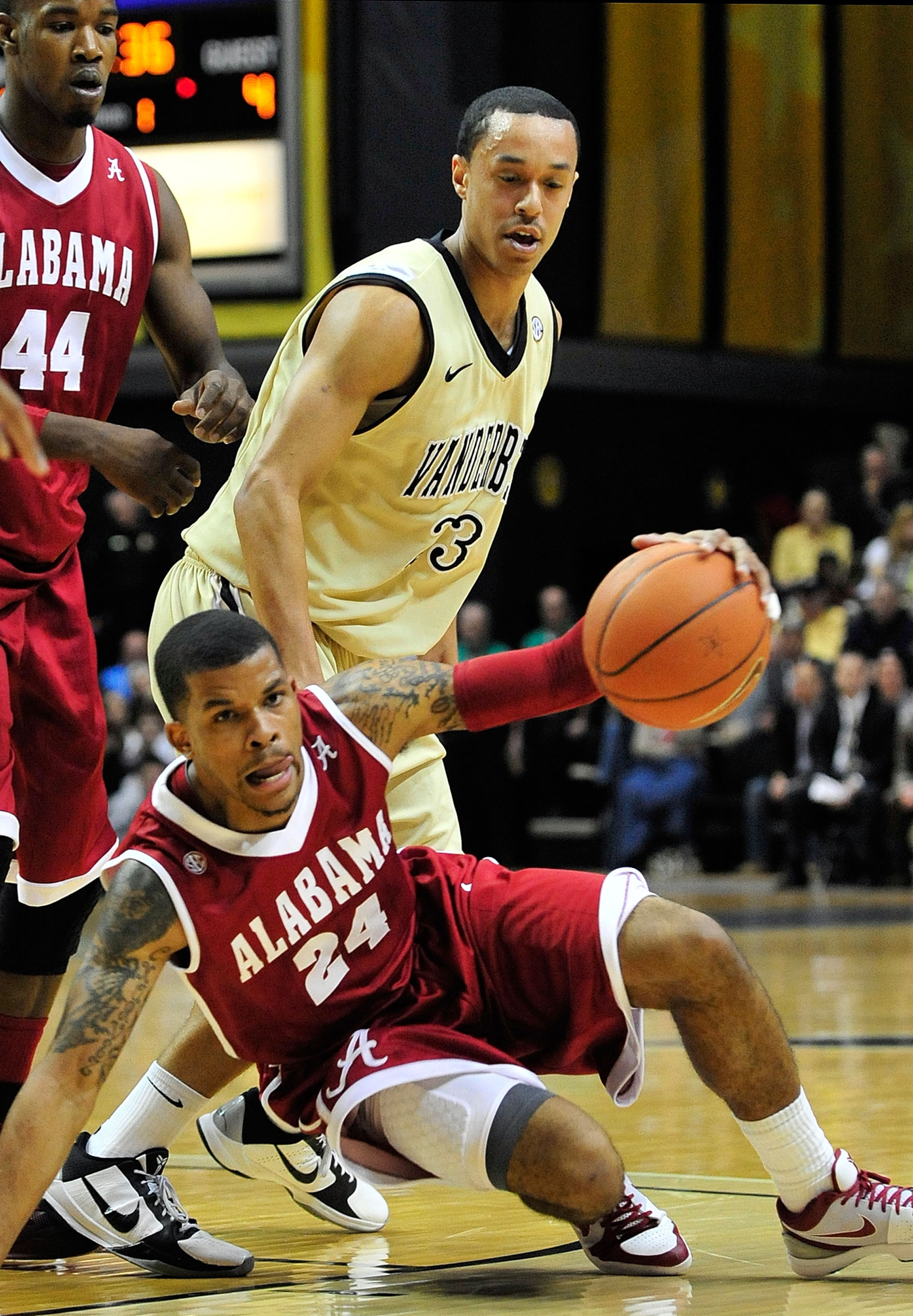 NASHVILLE, TN - FEBRUARY 10:  Charvez Davis #24 of the Alabama Crimson Tide maintains his dribble after colliding with John Jenkins #23 of the Vanderbilt Commodores at Memorial Gym on February 10, 2011 in Nashville, Tennessee.  (Photo by Grant Halverson/G