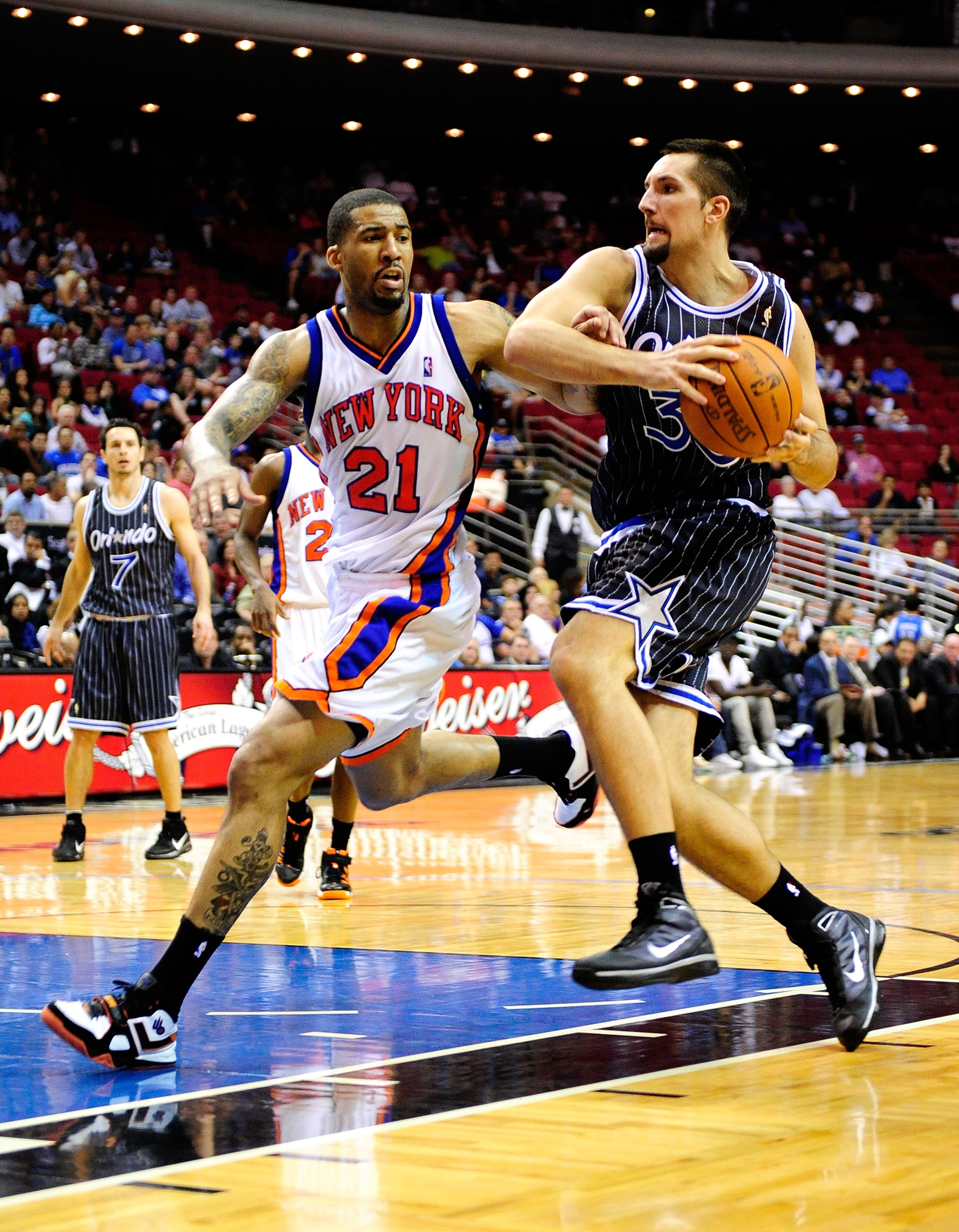 ORLANDO, FL - DECEMBER 02:  Ryan Anderson #33 of the Orlando Magic drives against Wilson Chandler #21 of the New York Knicks during the game at Amway Arena on December 2, 2009 in Orlando, Florida.  NOTE TO USER: User expressly acknowledges and agrees that