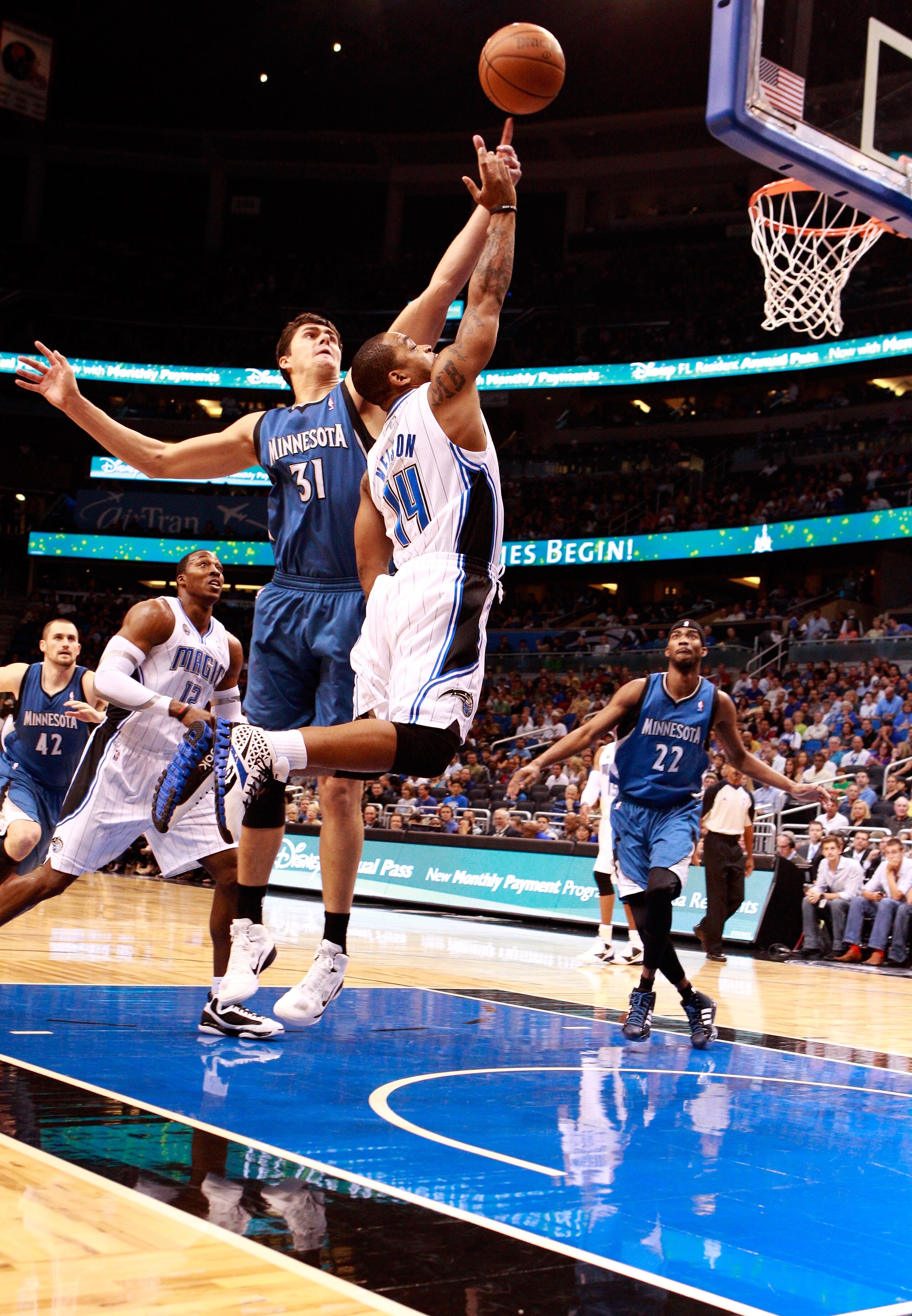 ORLANDO, FL - NOVEMBER 03:  Jameer Nelson #14 of the Orlando Magic attempts to score over Darko Milicic #31 of the Minnesota Timberwolvesduring the game at Amway Arena on November 3, 2010 in Orlando, Florida.  NOTE TO USER: User expressly acknowledges and