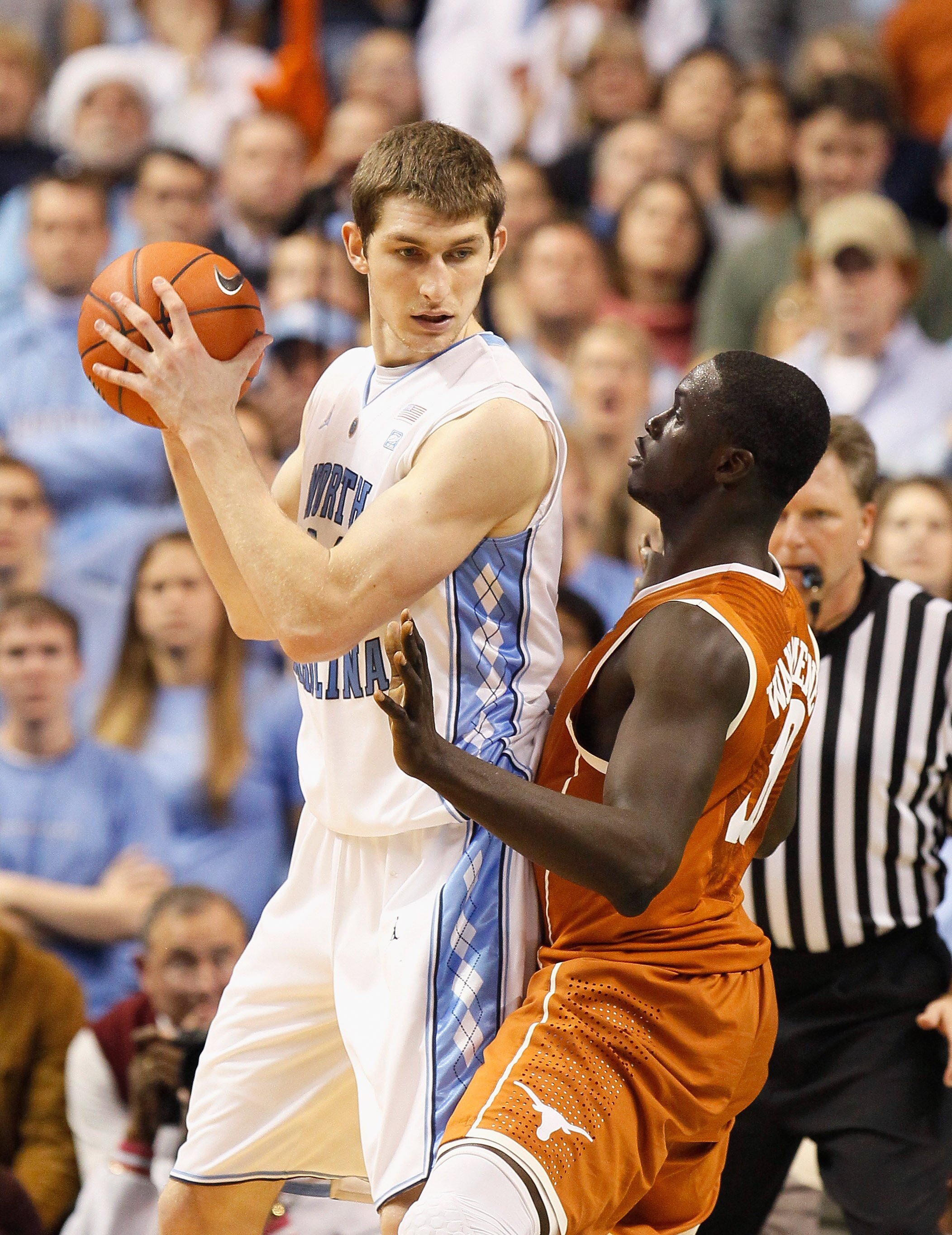 GREENSBORO, NC - DECEMBER 18:  Tyler Zeller #44 of the North Carolina Tar Heels against Alexis Wangmene #20 of the Texas Longhorns at Greensboro Coliseum on December 18, 2010 in Greensboro, North Carolina.  (Photo by Kevin C. Cox/Getty Images)
