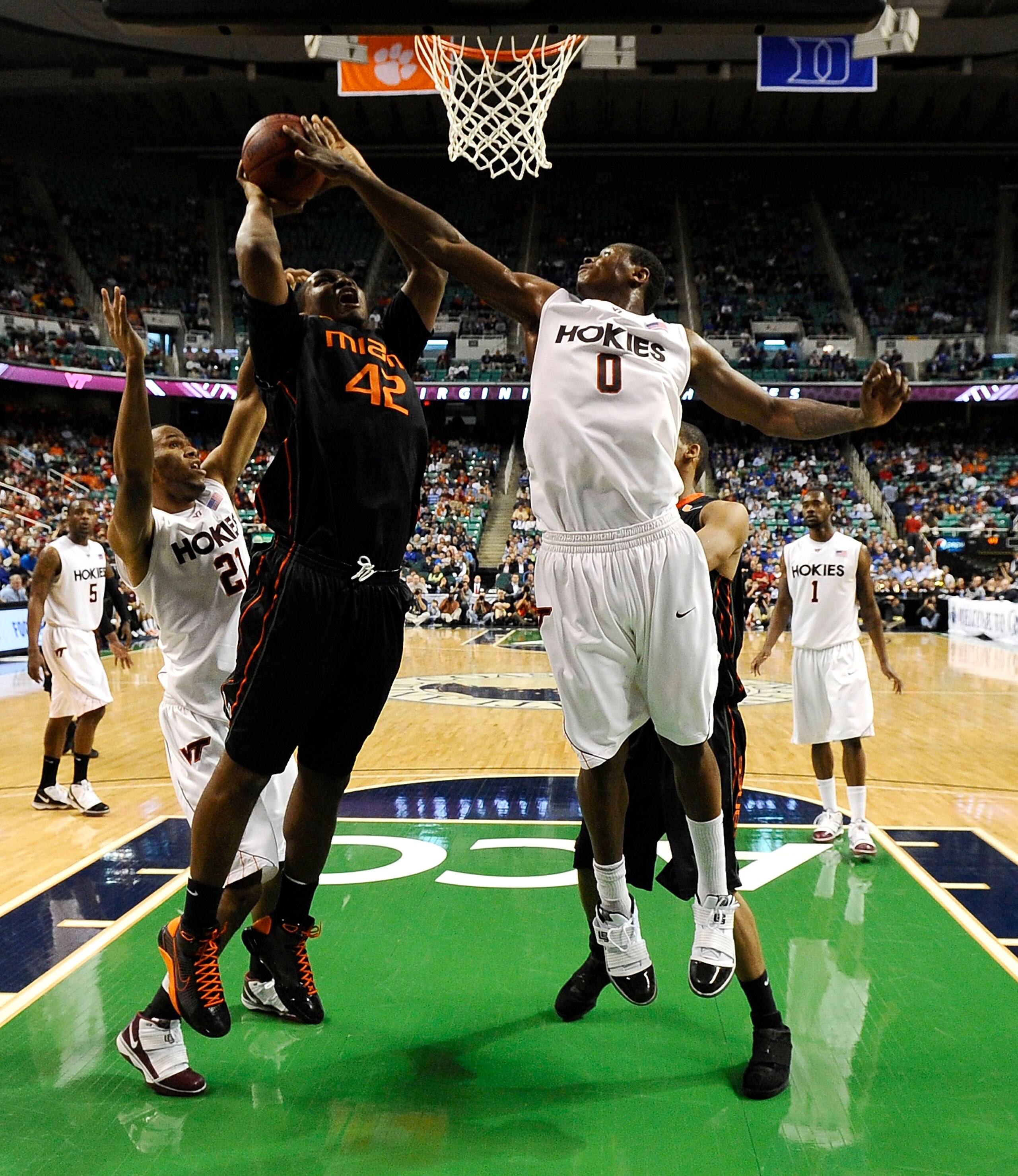 GREENSBORO, NC - MARCH 12:  Jeff Allen #00 of the Virginia Tech Hokies defends  Reggie Johnson #42 of the University of Miami Hurricanes in their quarterfinal game in the 2010 ACC Men's Basketball Tournament at the Greensboro Coliseum on March 12, 2010 in