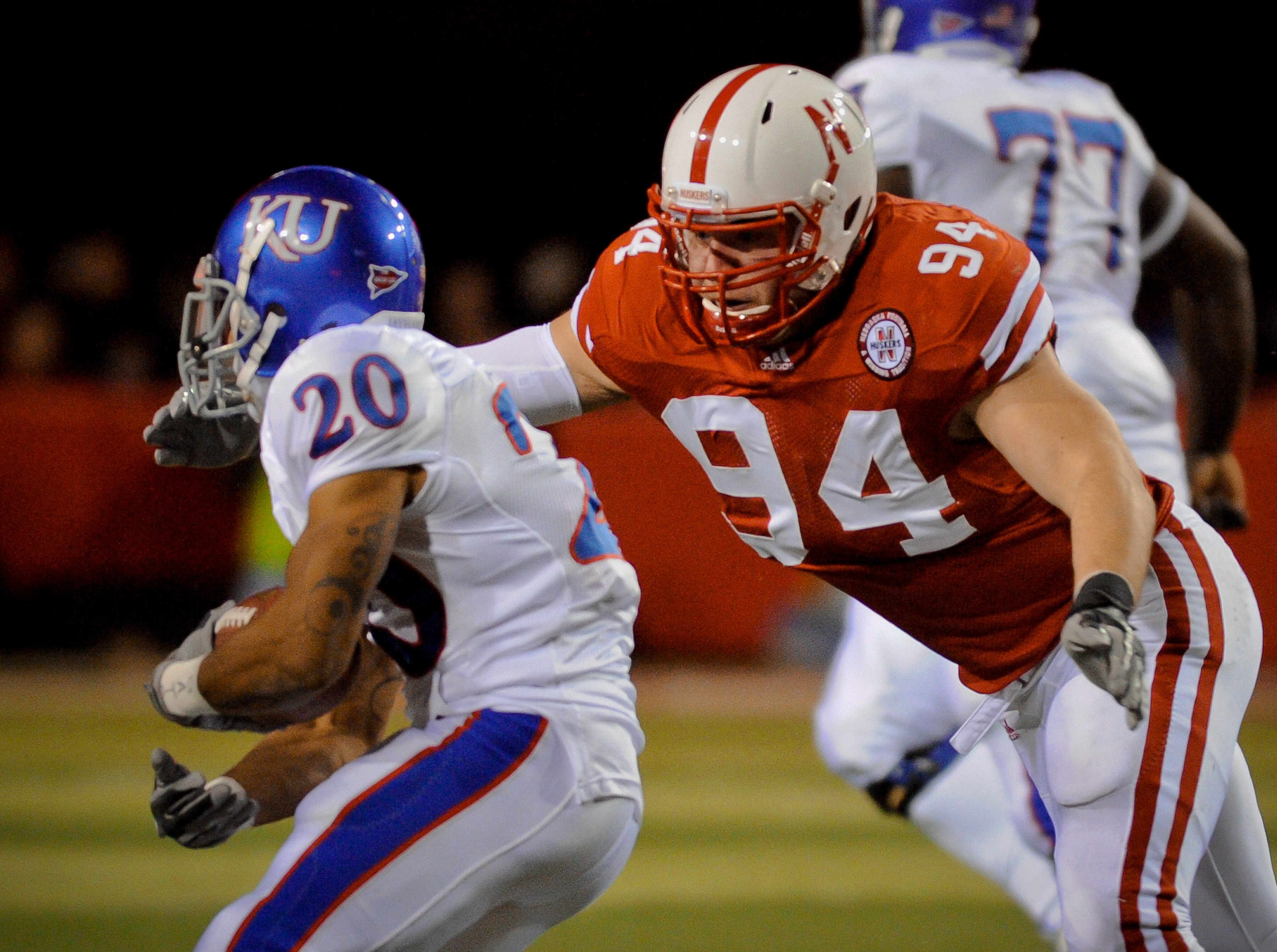 LINCOLN, NE - NOVEMBER 13: Jared Crick #94 of the Nebraska Cornhuskers runs down D.J. Beshears #20 of the Kansas Jayhawks during first half action of their game at Memorial Stadium on November 13, 2010 in Lincoln, Nebraska.  (Photo by Eric Francis/Getty I