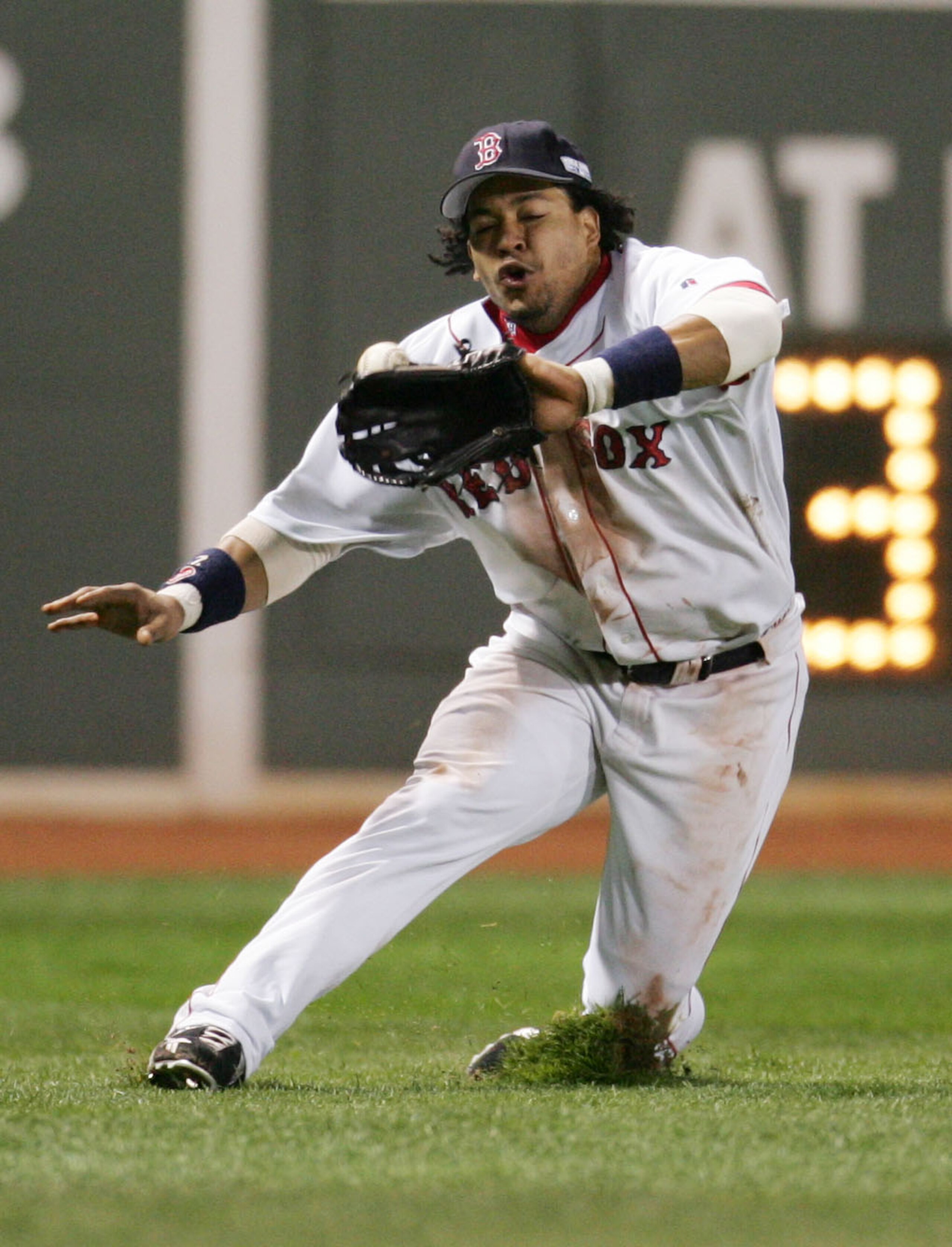 BOSTON - OCTOBER 23:  Left fielder Manny Ramirez #24 of the Boston Red Sox misplays a line-drive hit by Larry Walker #33 of the St. Louis Cardinals in the eighth inning during game one of the World Series on October 23, 2004 at Fenway Park in Boston, Mass